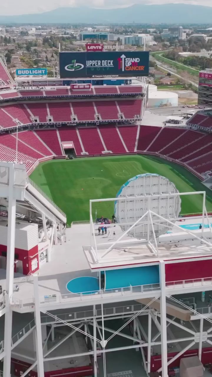 Aerial view of Levi's Stadium field, with red seating and large scoreboard, showing the vibrant venue for events.