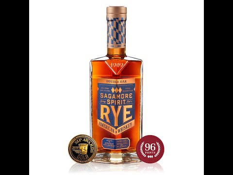 Sagamore Spirit Double Oak Rye Whiskey bottle with awards, showcasing its rich amber color and distinctive label.