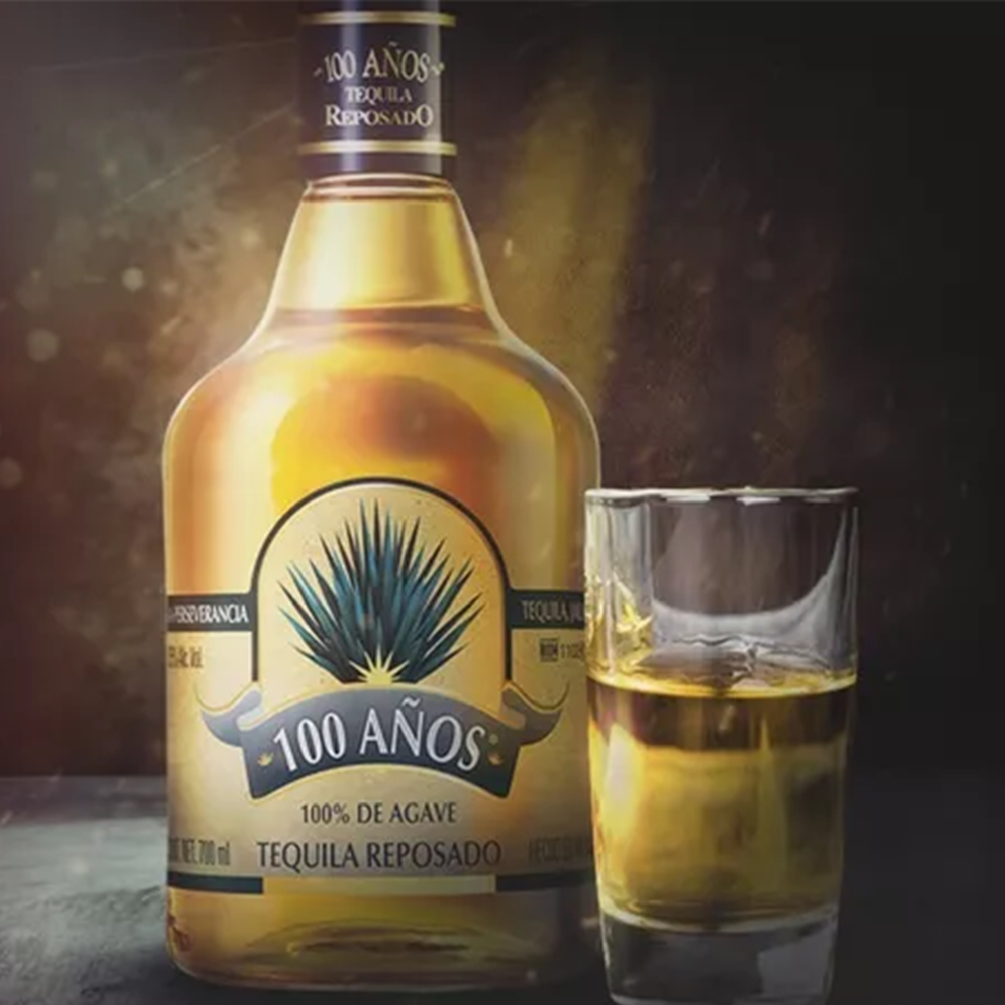 100 Años Reposado Tequila bottle with glass, showcasing bright bronze color and 100% Blue Agave quality.