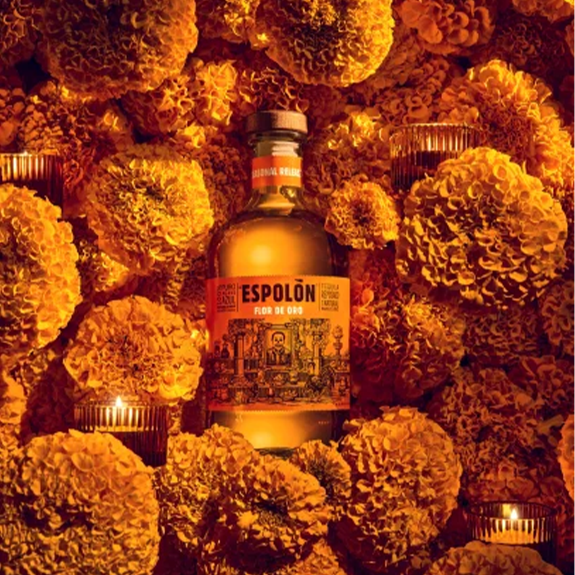 Espolón Flor de Oro Reposado Tequila bottle surrounded by vibrant marigold flowers, celebrating Día de Los Muertos.