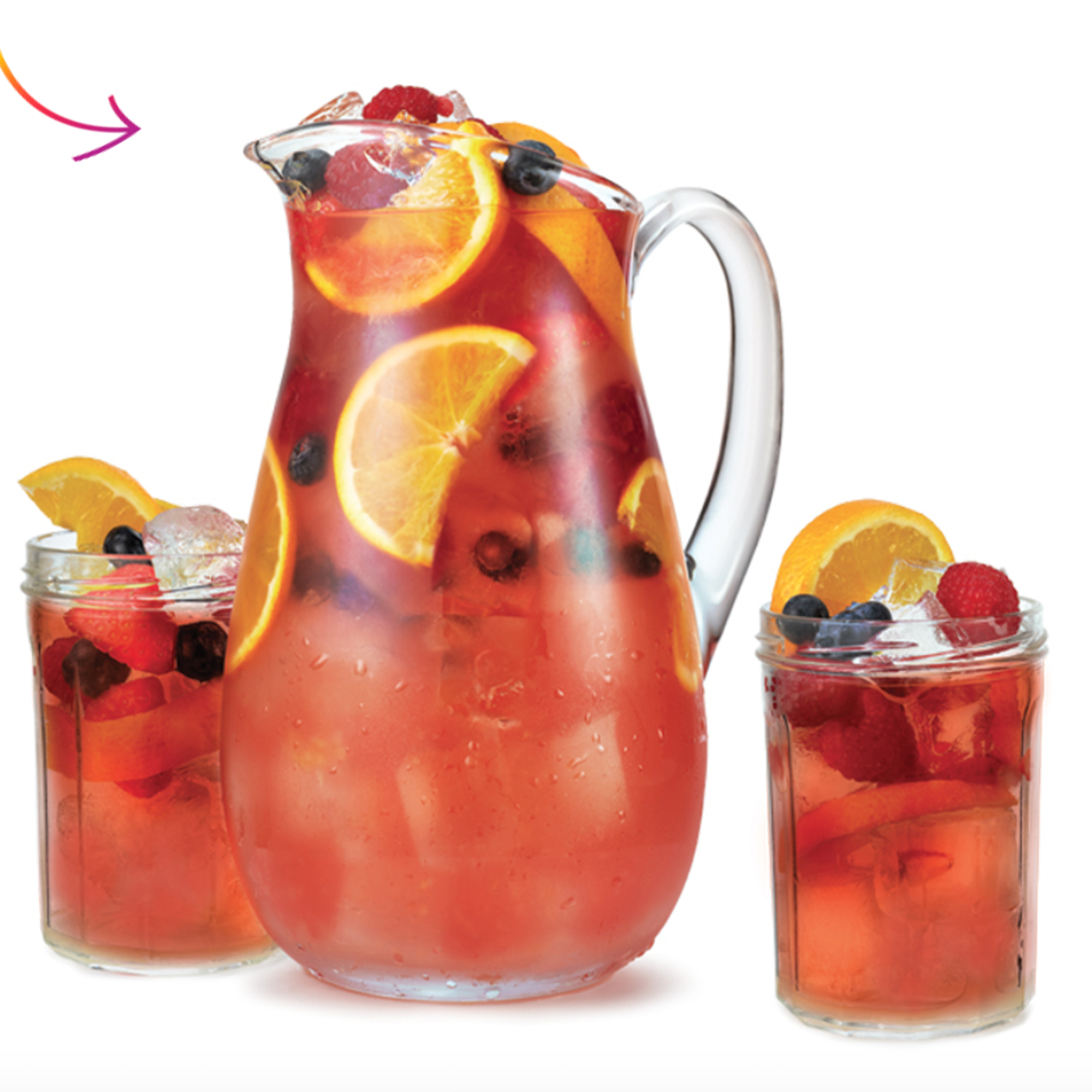 Colorful fruit punch in a pitcher with ice and fresh fruits, served with two glasses filled with mixed berries.
