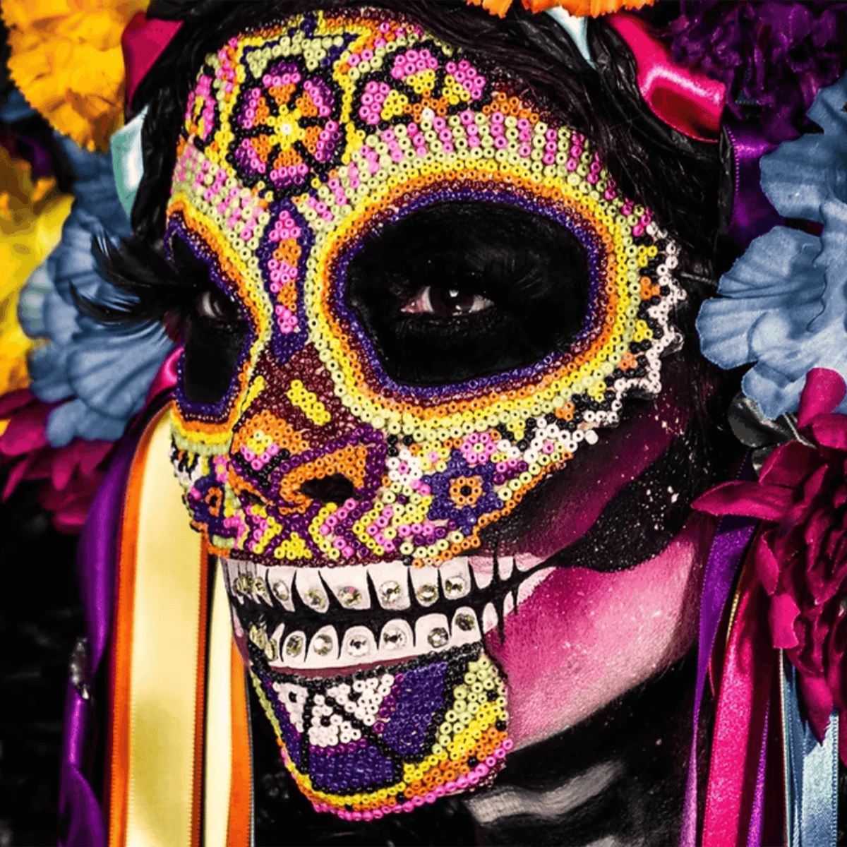 Colorful Day of the Dead face paint with intricate designs and floral adornments, showcasing Mexican folklore aesthetics.