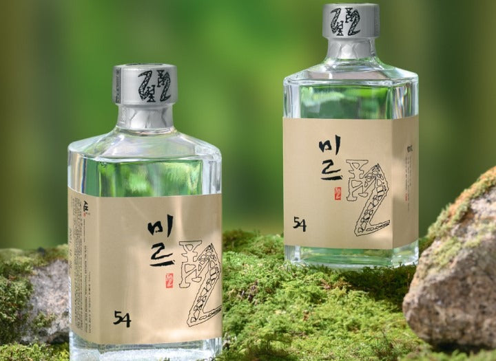 Sulseam Mir 22 Soju 375mL bottles on mossy stones, showcasing traditional Korean rice-based liquor.