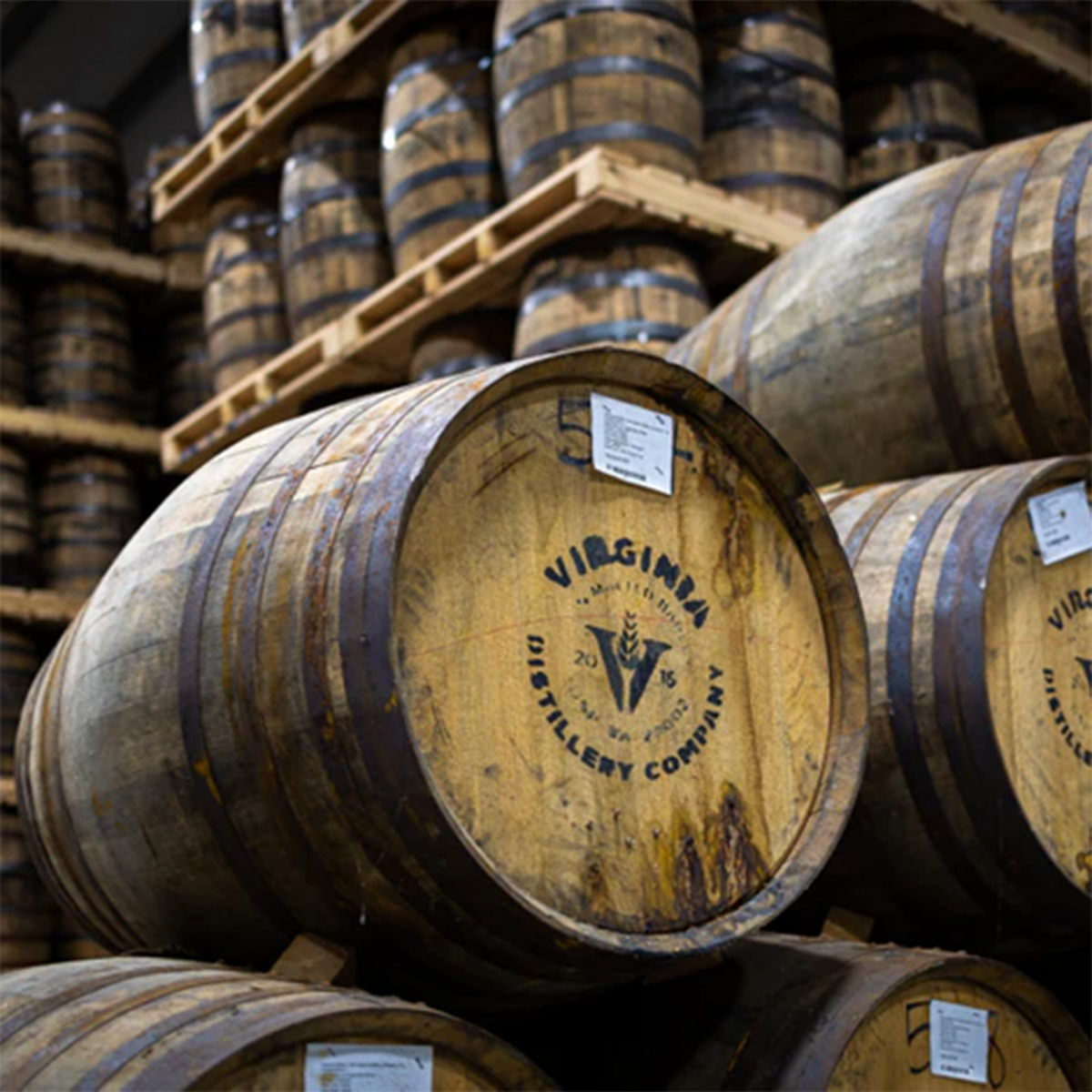 Virginia Distillery Company barrels stacked in a distillery for aging whiskey.