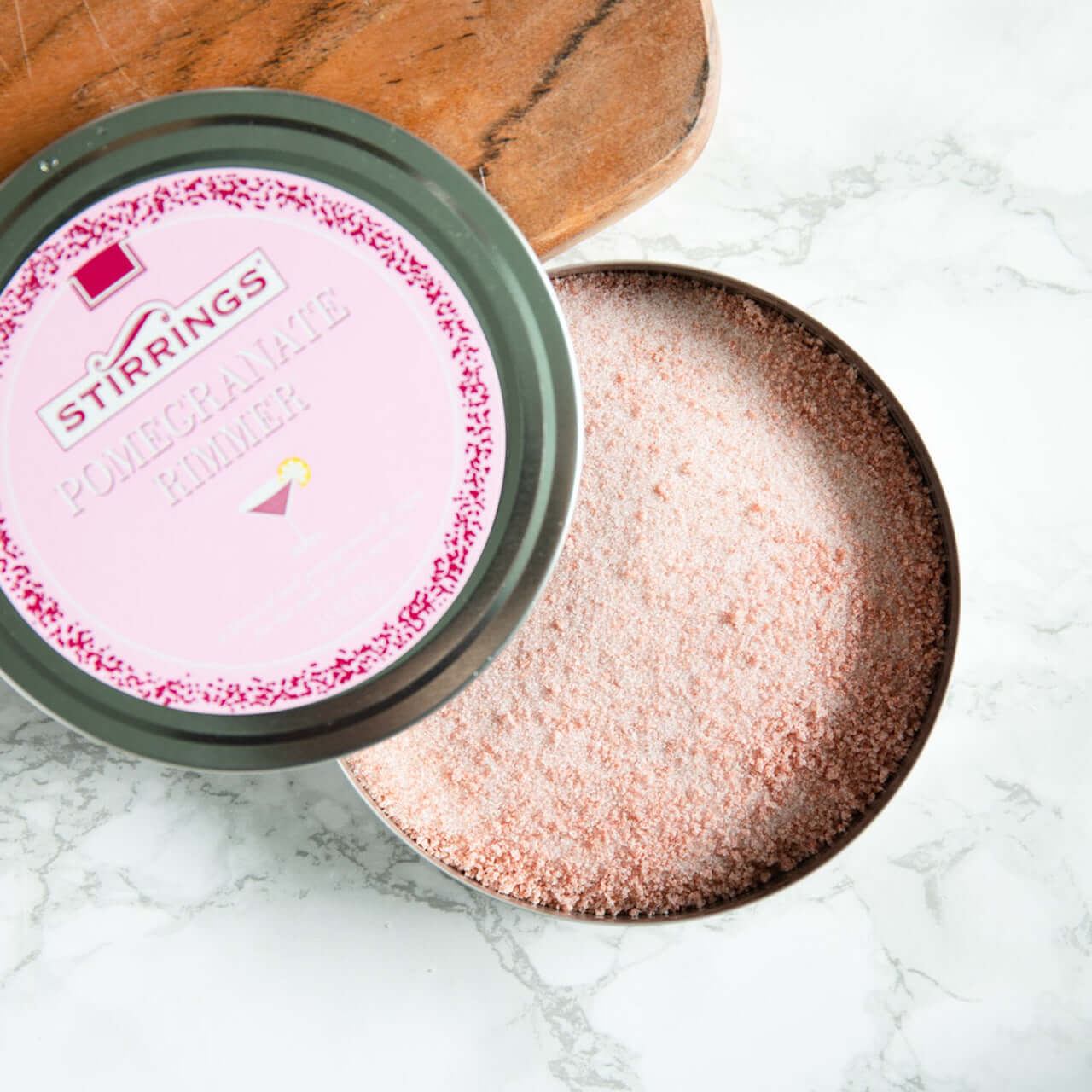 Stirrings Pomegranate Rimmer in a tin, ideal for garnishing cocktails with crushed pomegranate and sugar.