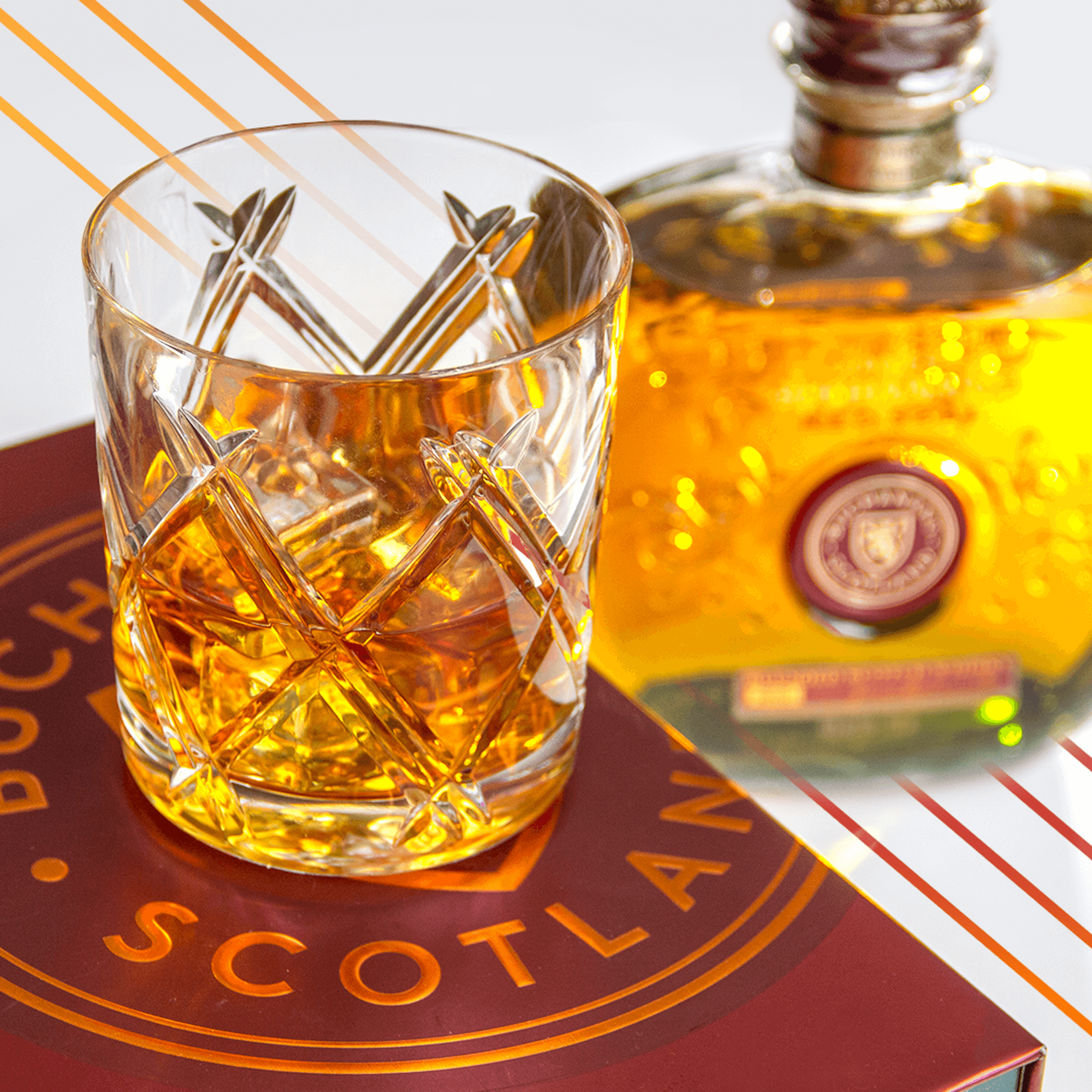 Buchanan's Red Seal whisky in a crystal glass next to the bottle, with a rich amber color and elegant packaging.