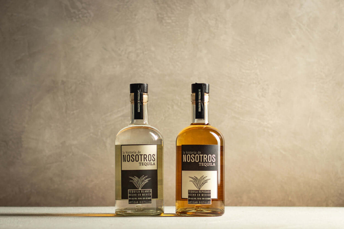 Nosotros Tequila bottles, featuring blanco and reposado varieties, set against a textured background.