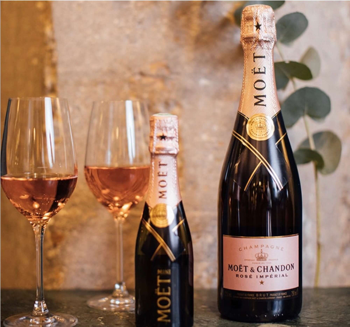 Moët & Chandon Rosé Impérial champagne bottles with glasses, embodying elegance and vibrant flavors.