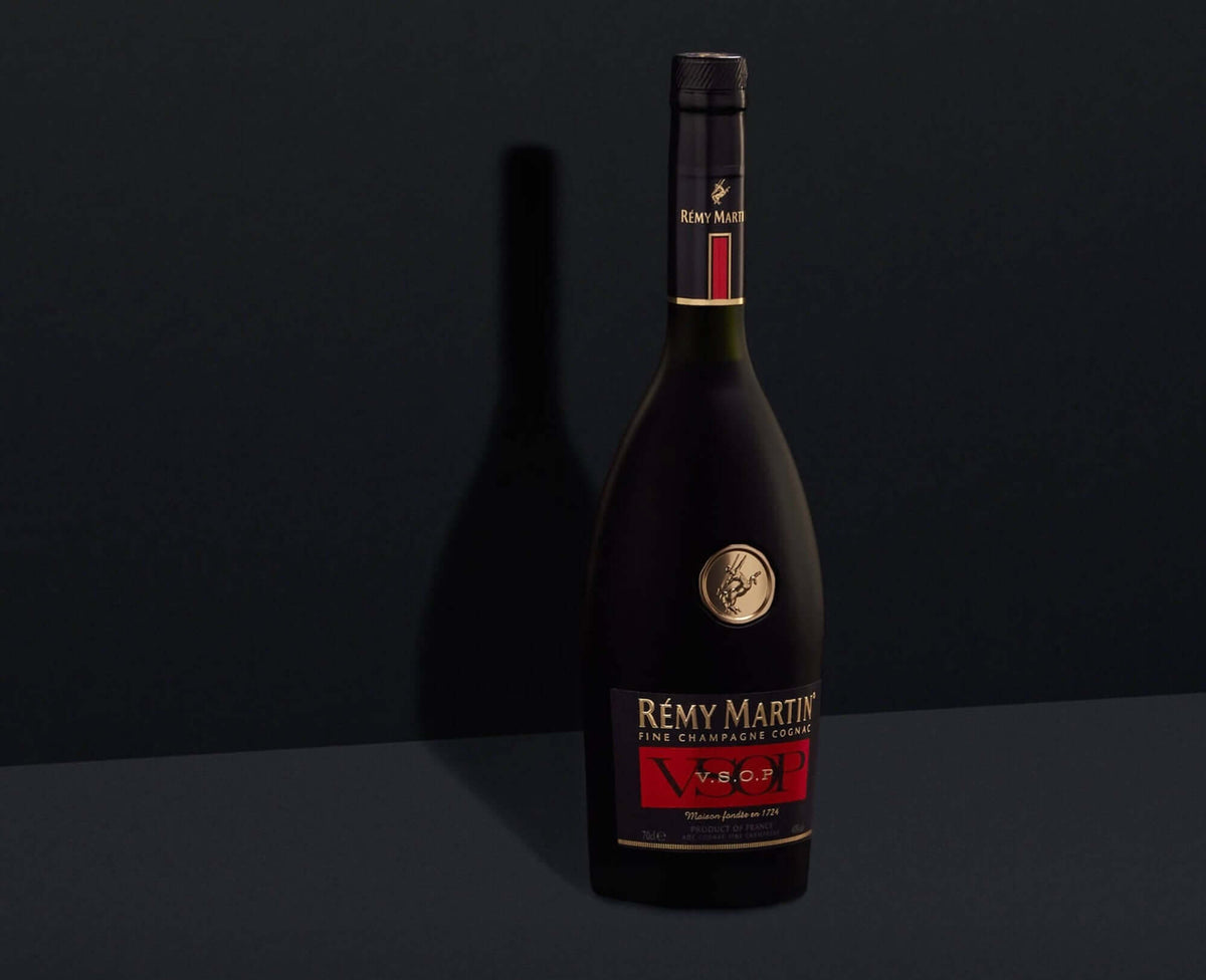 Rémy Martin VSOP Cognac bottle with elegant label on a dark background, showcasing its fine craftsmanship.
