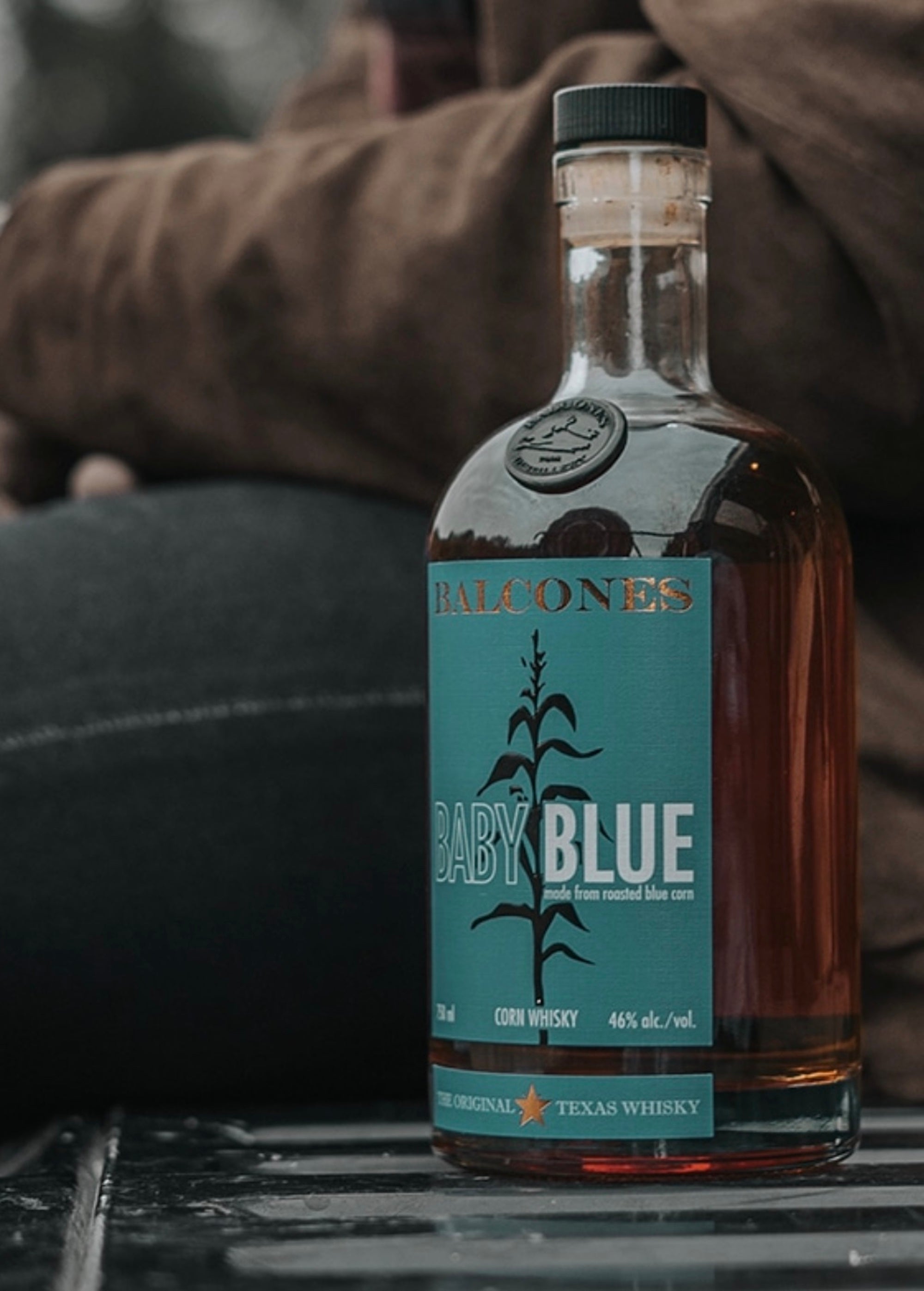 Balcones Baby Blue Corn Whiskey bottle featuring a vibrant label, showcasing Texas craftsmanship and unique flavor notes.