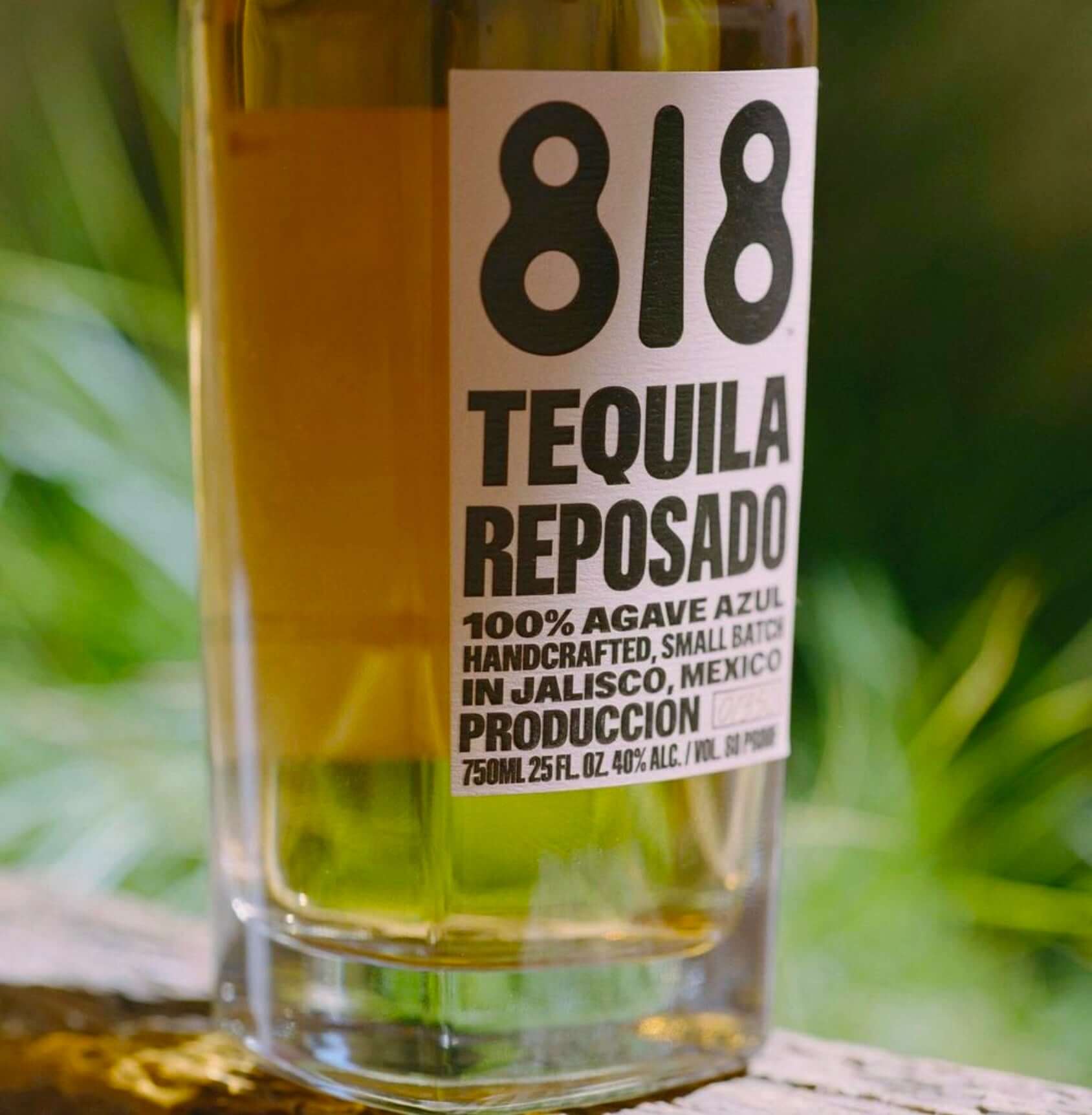 818 Reposado Tequila bottle showcasing 100% agave, handcrafted in Jalisco, Mexico with a smooth flavor profile.