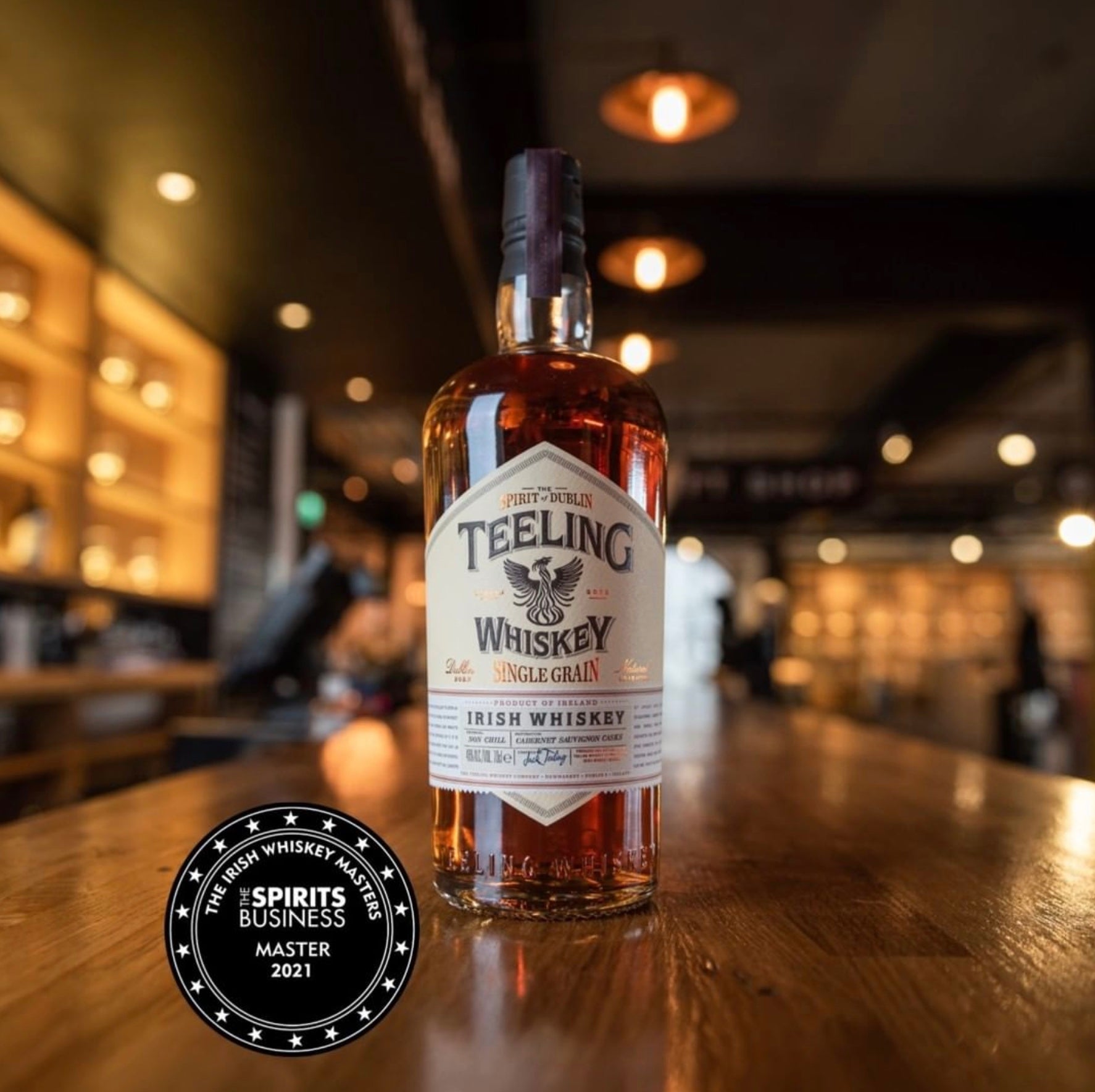 Teeling Single Grain Irish Whiskey bottle on a bar showcasing its unique French oak cask maturation.