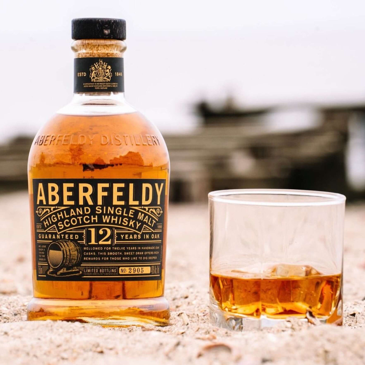 Bottle of Aberfeldy 12 Year Highland Single Malt Scotch Whisky next to a glass of whisky.