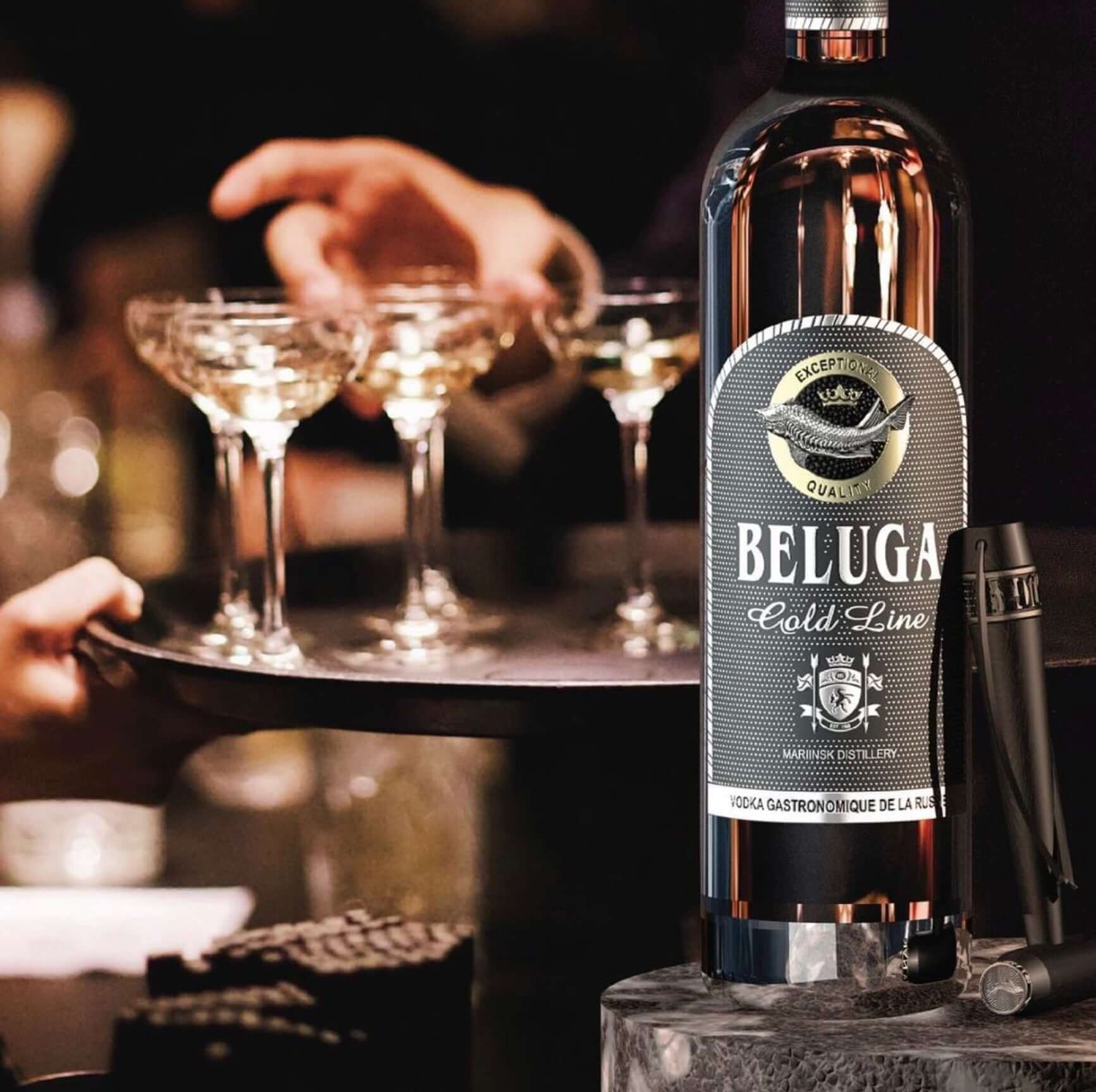 Beluga Gold Line Russian Vodka 750ml on a serving tray with cocktails, showcasing its premium quality and elegance.
