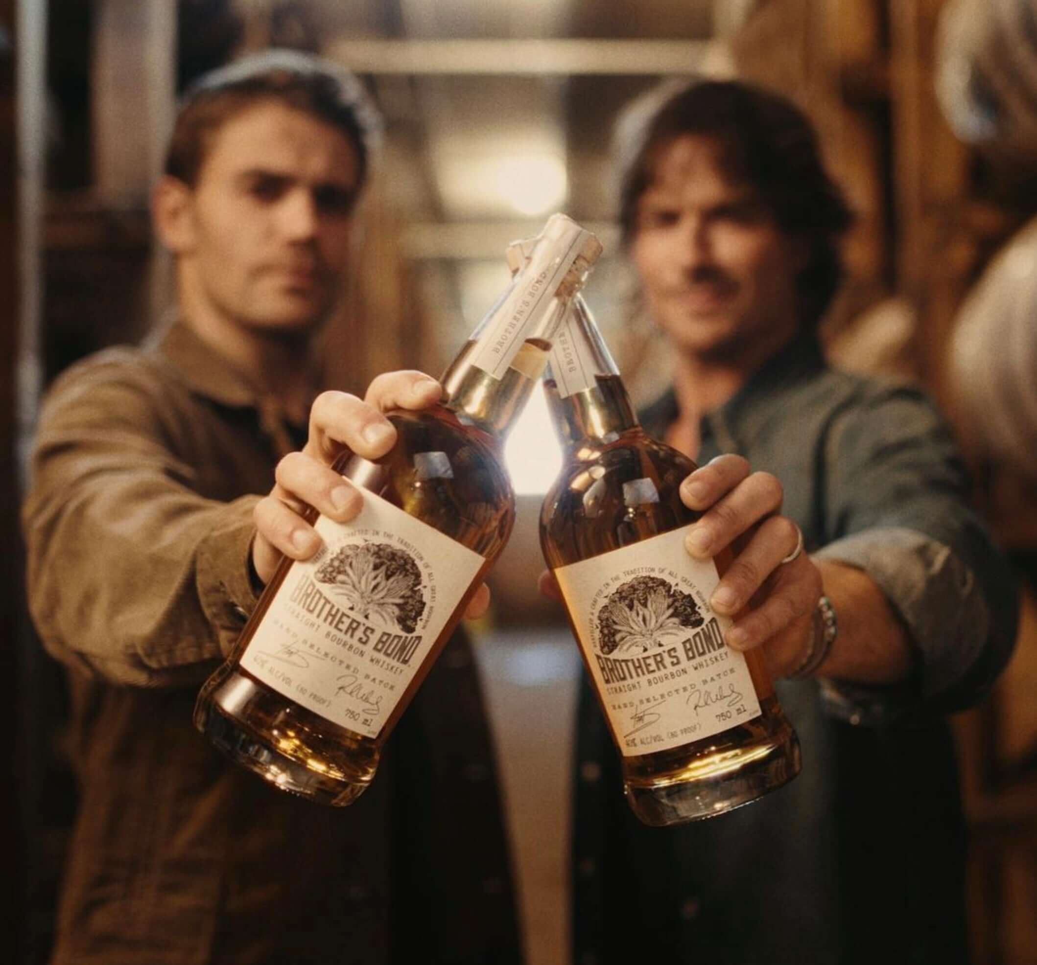 Brother's Bond Straight Bourbon bottles held by Ian Somerhalder and Paul Wesley, celebrating their friendship.