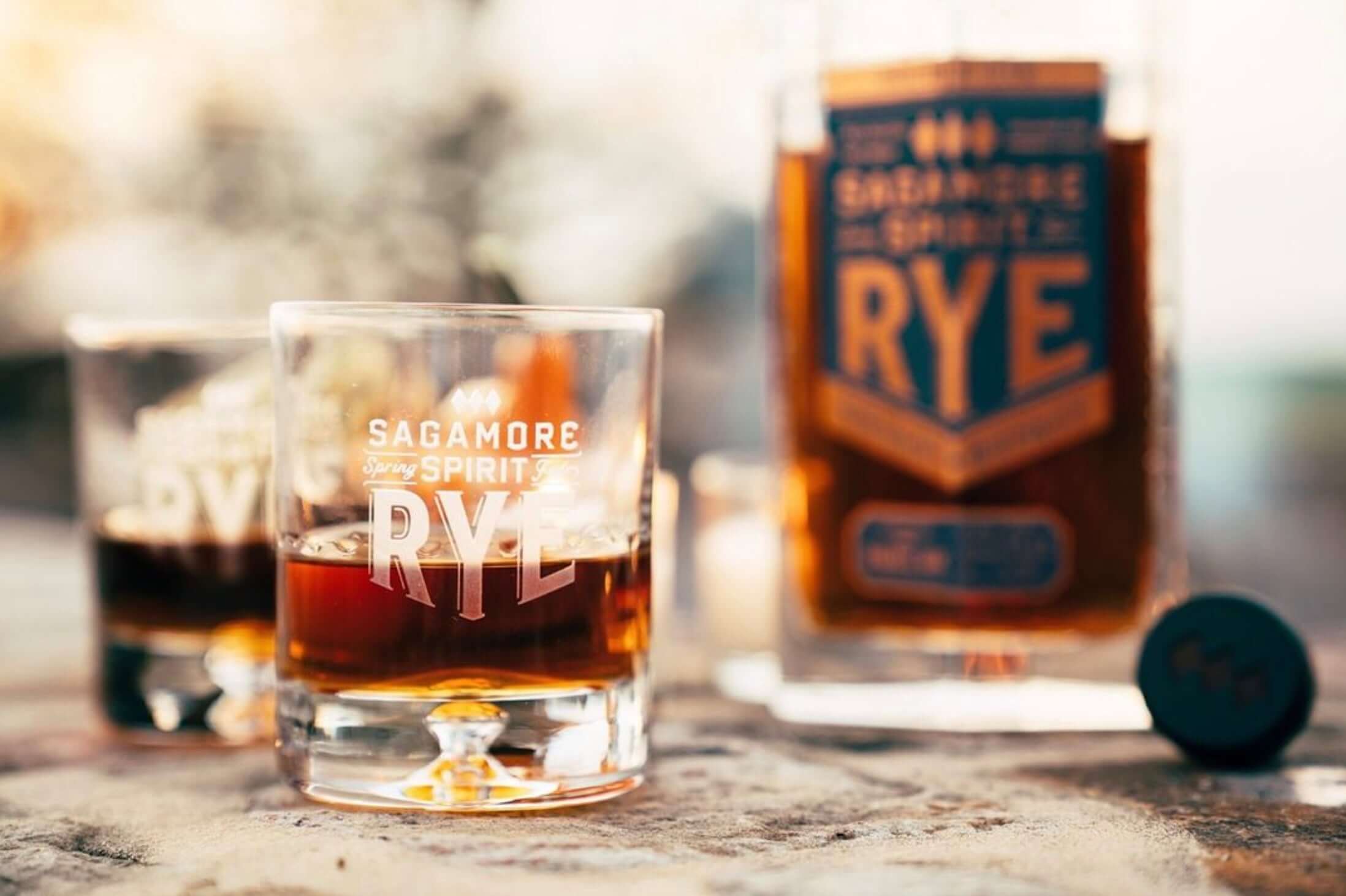 Two glasses of Sagamore Spirit Double Oak Rye Whiskey with a bottle, highlighting rich caramel and toffee notes.