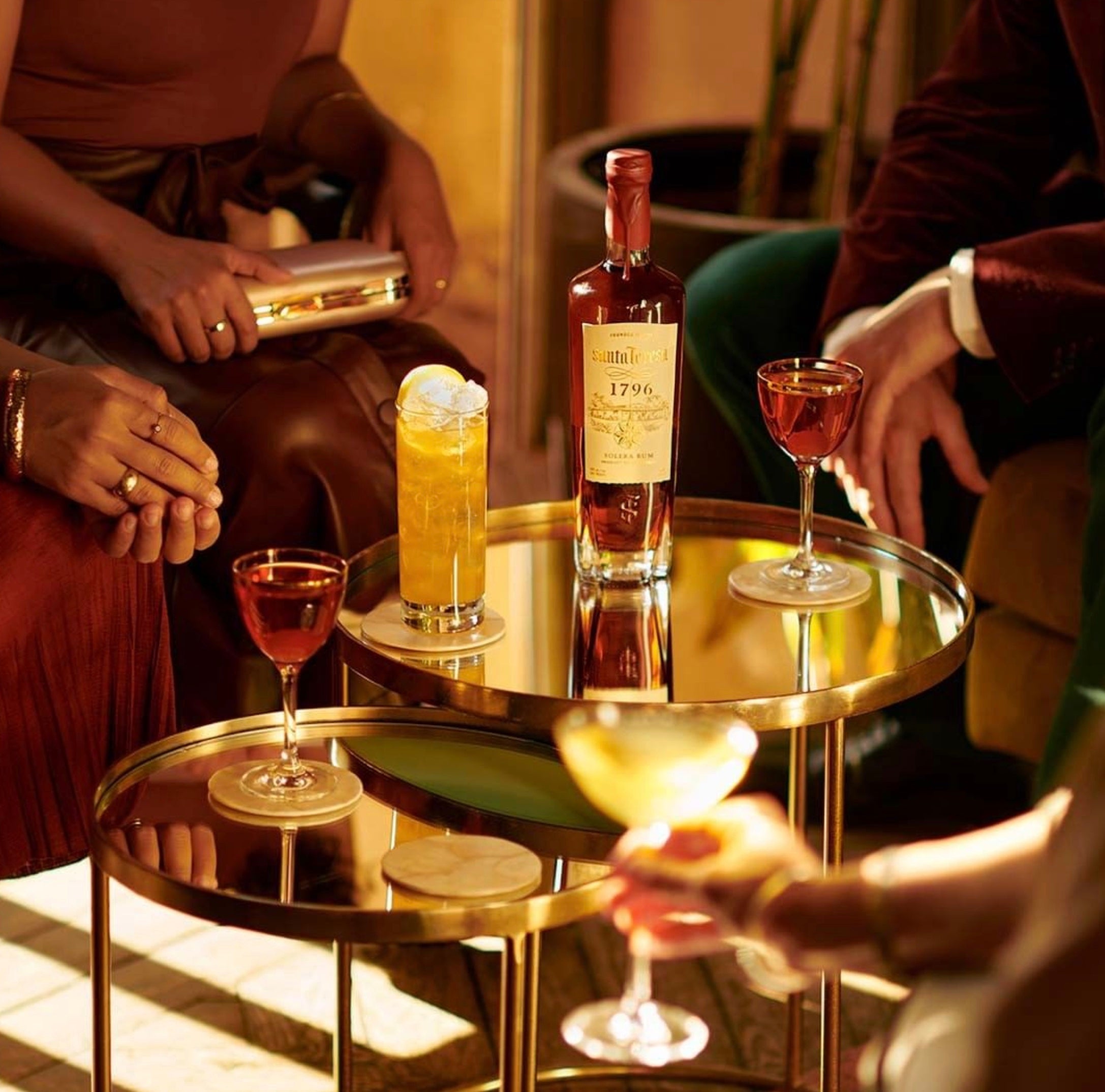Santa Teresa 1796 Venezuelan Rum displayed on a table with cocktails in a stylish setting, perfect for celebrations.