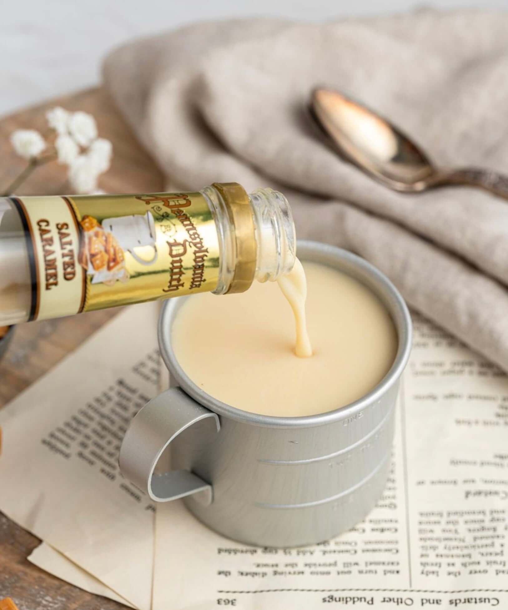 Pouring Pennsylvania Dutch Salted Caramel into a cup, showcasing a creamy fall drink with rich flavors.