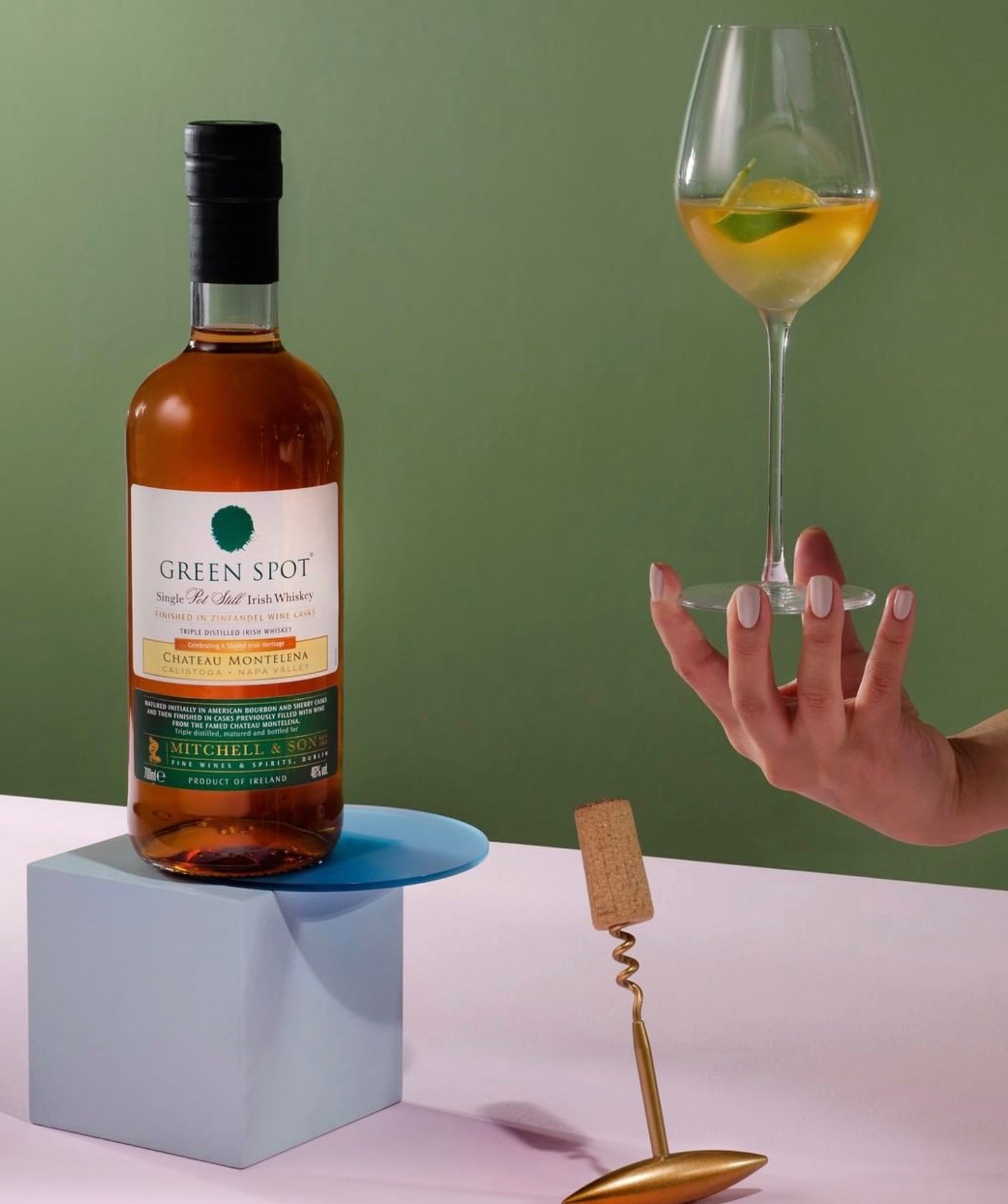 Green Spot Chateau Montelena Irish Whiskey bottle with a cocktail glass garnished with lemon