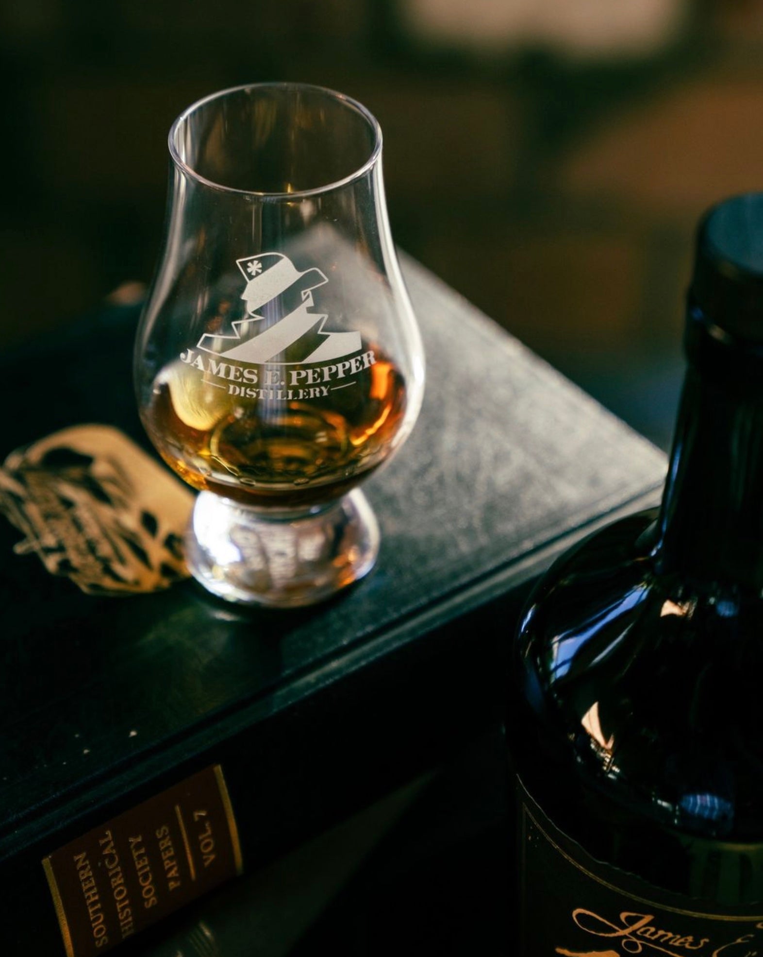 James E. Pepper bourbon glass with whiskey, showcasing heritage and craftsmanship in a classic setting.