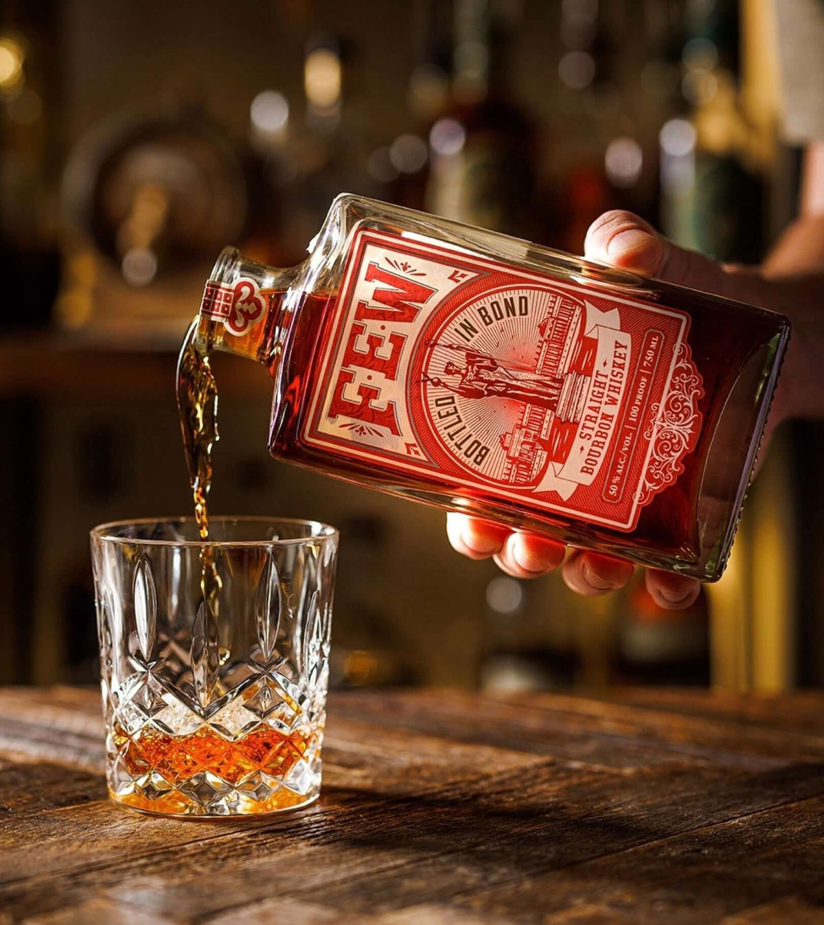 Pouring FEW Bottled in Bond Bourbon into a crystal glass, highlighting its rich color and quality craftsmanship.
