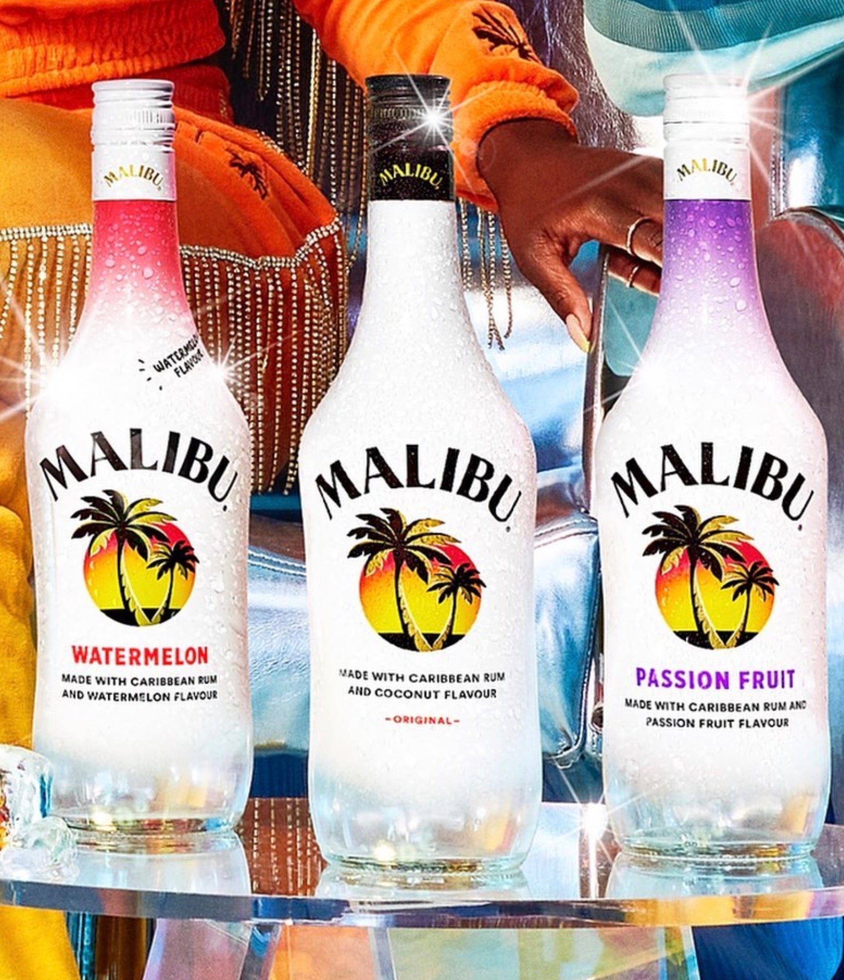 Three Malibu rum bottles: Watermelon, Original, and Passion Fruit flavors, perfect for summer cocktails.
