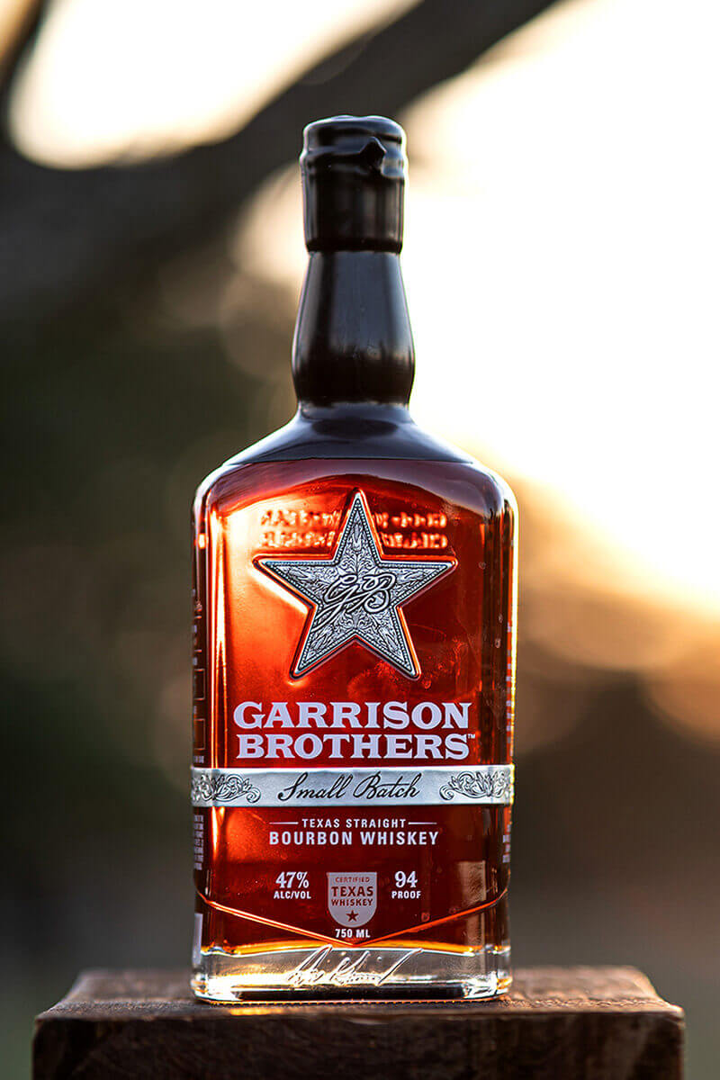 Garrison Brothers Small Batch Whiskey bottle with star logo, showcasing amber color and Hye, Texas branding.