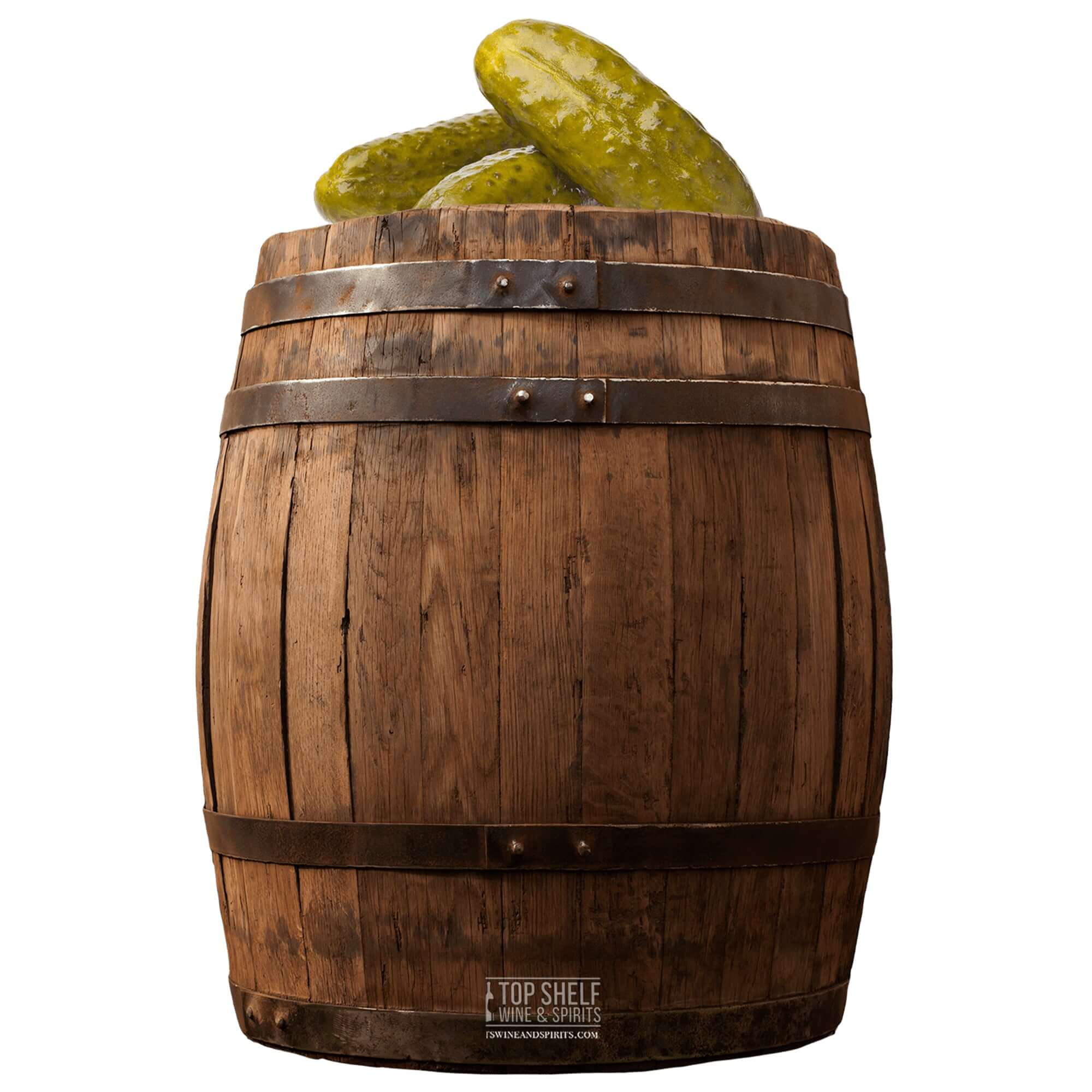 Wooden barrel filled with green pickles, showcasing a rustic storage for spicy pickled whiskey.