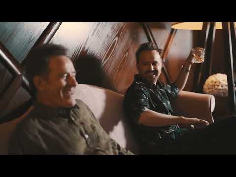Two men enjoying Dos Hombres Mezcal Espadin Joven in a cozy setting, savoring its smooth flavors.