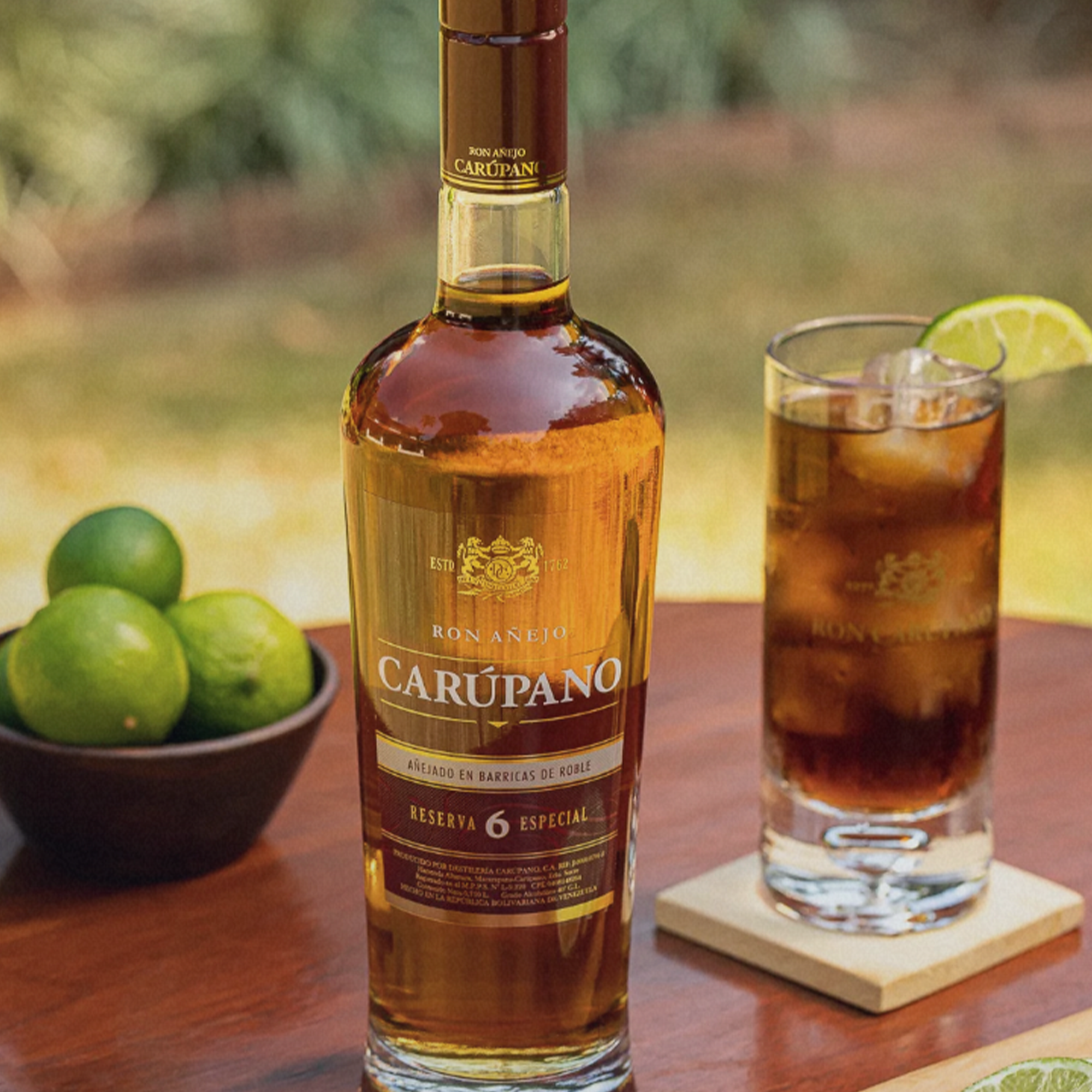 Bottle of Ron Carupano Riserva Especial 6 Year Rum with cocktail and limes on a wooden table.