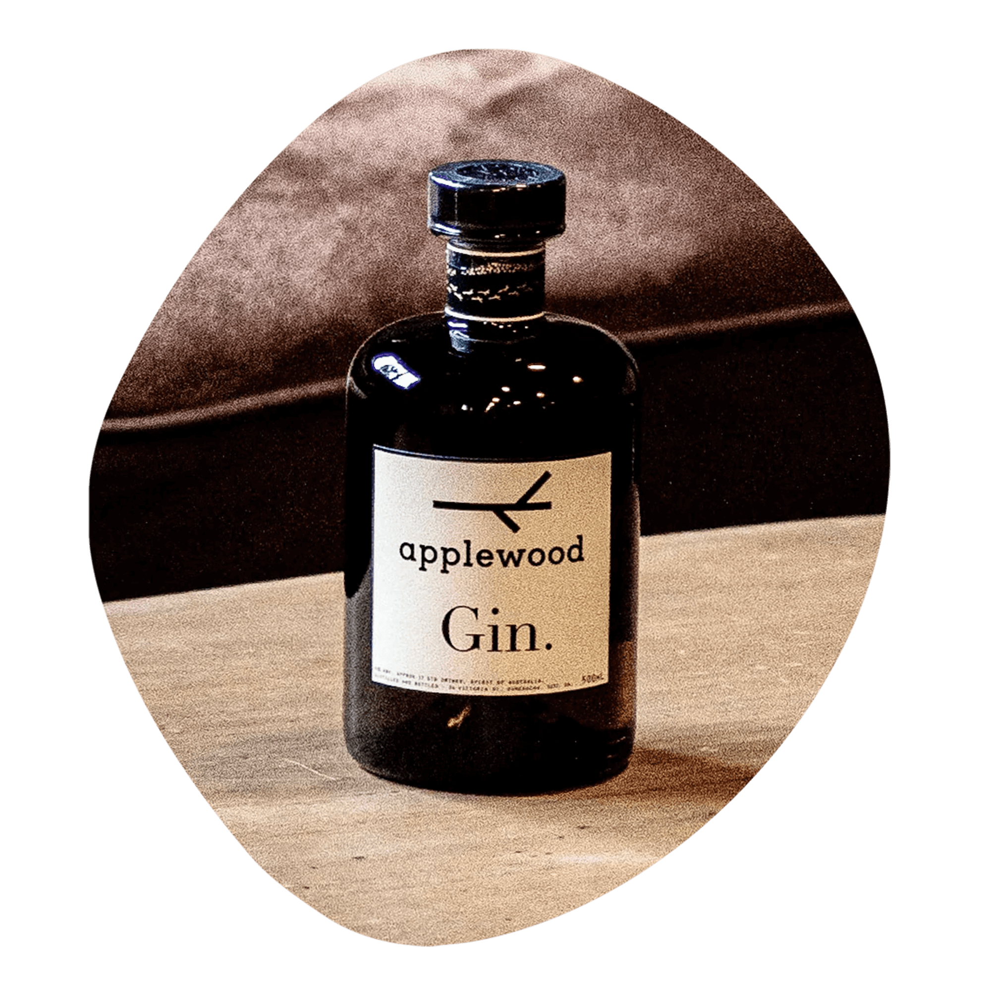 Applewood Australian Gin bottle on a wooden table, showcasing its unique dry gin character and modern design.