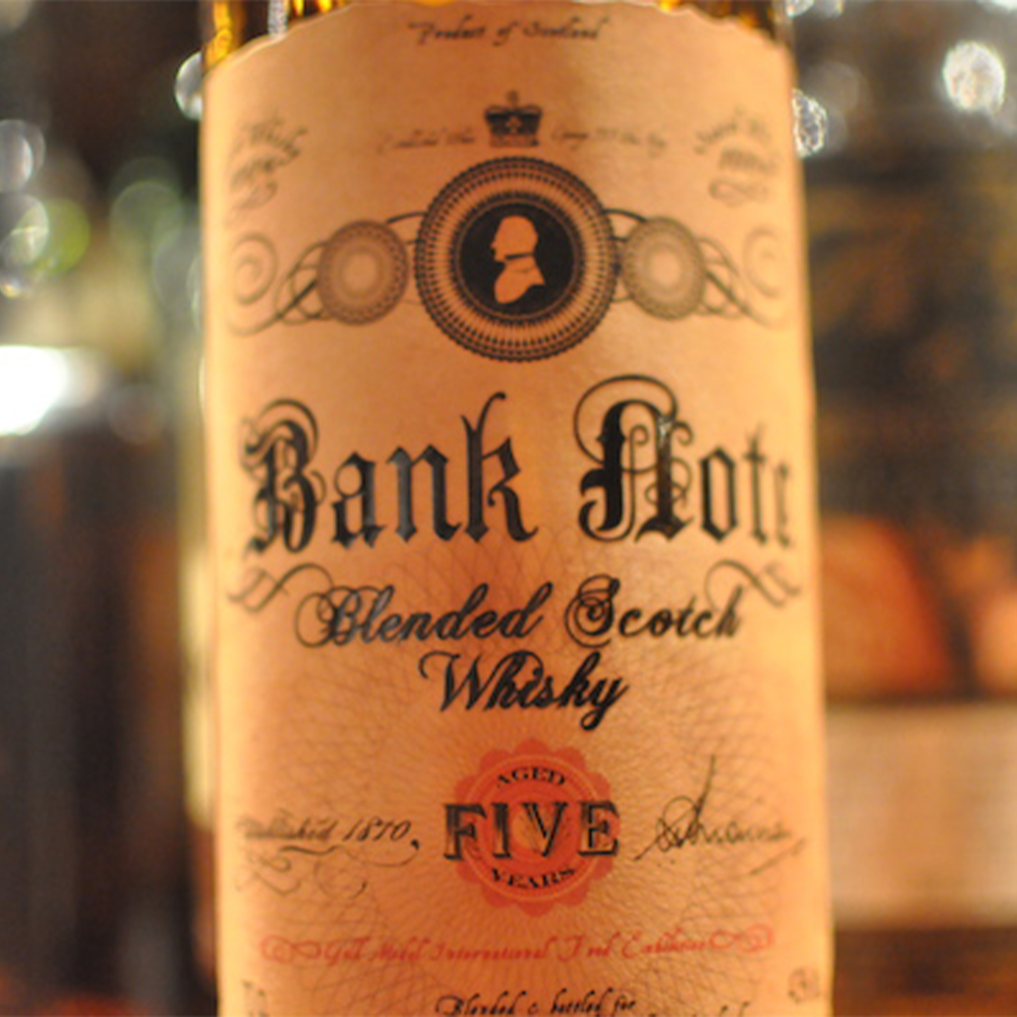 Close-up of Bank Note 5 Year Blended Whisky bottle showcasing its vintage label design.