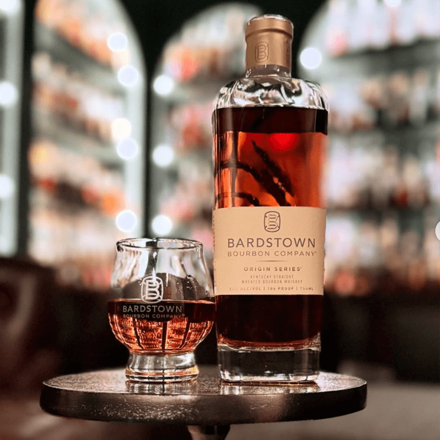Bardstown Origin Series Wheated Bourbon bottle and glass on display, highlighting its rich color and elegant presentation.