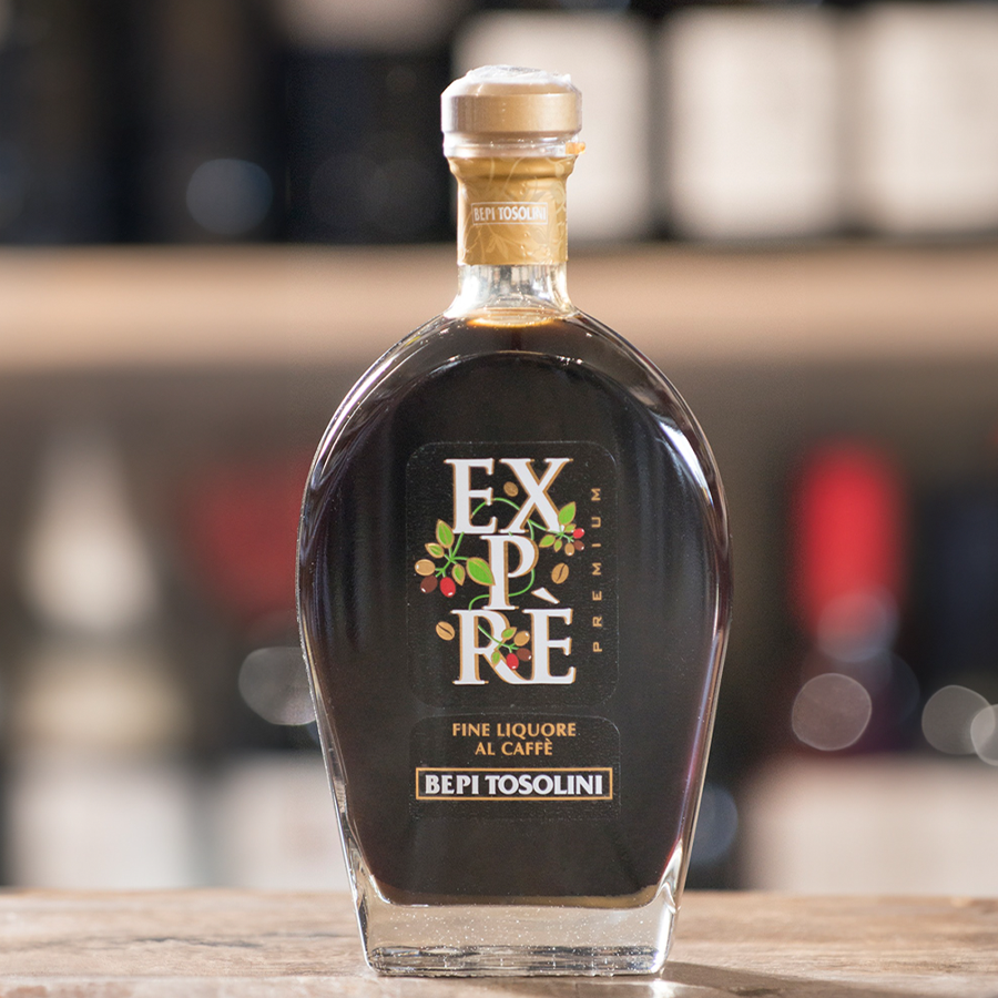 Bepi Tosolini Expre Coffee Liqueur bottle on a wooden surface with blurred background.