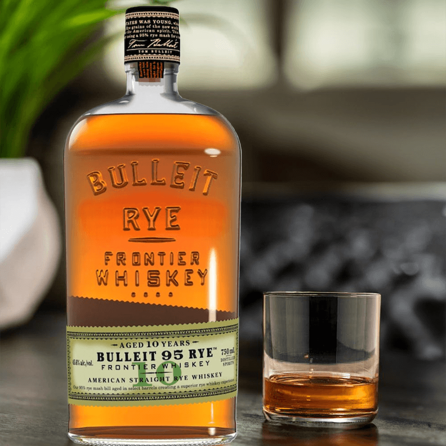 Bulleit 95 Rye 10 Year Frontier Whiskey bottle with a glass of whiskey, showcasing its rich amber color.
