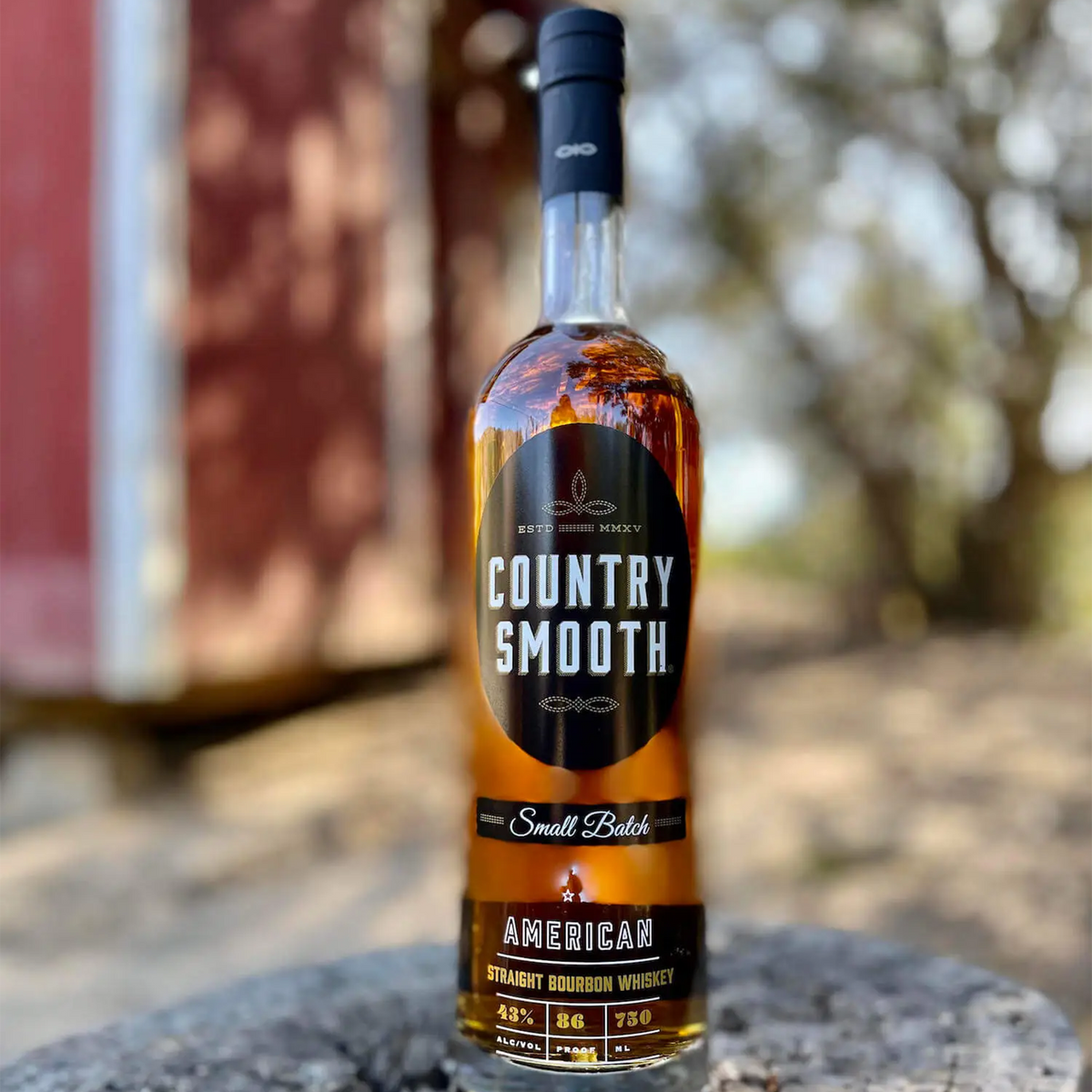 Country Smooth Small Batch American Straight Bourbon in a picturesque outdoor setting.