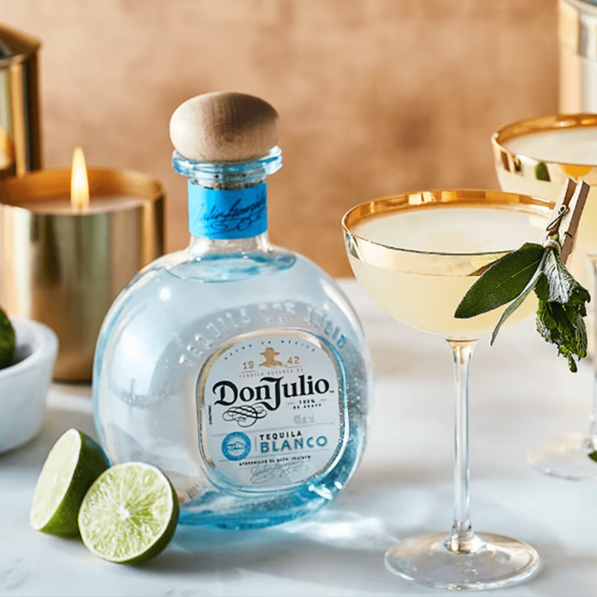 Don Julio Blanco Tequila 1L bottle with margarita glass and lime slices, perfect for cocktails.