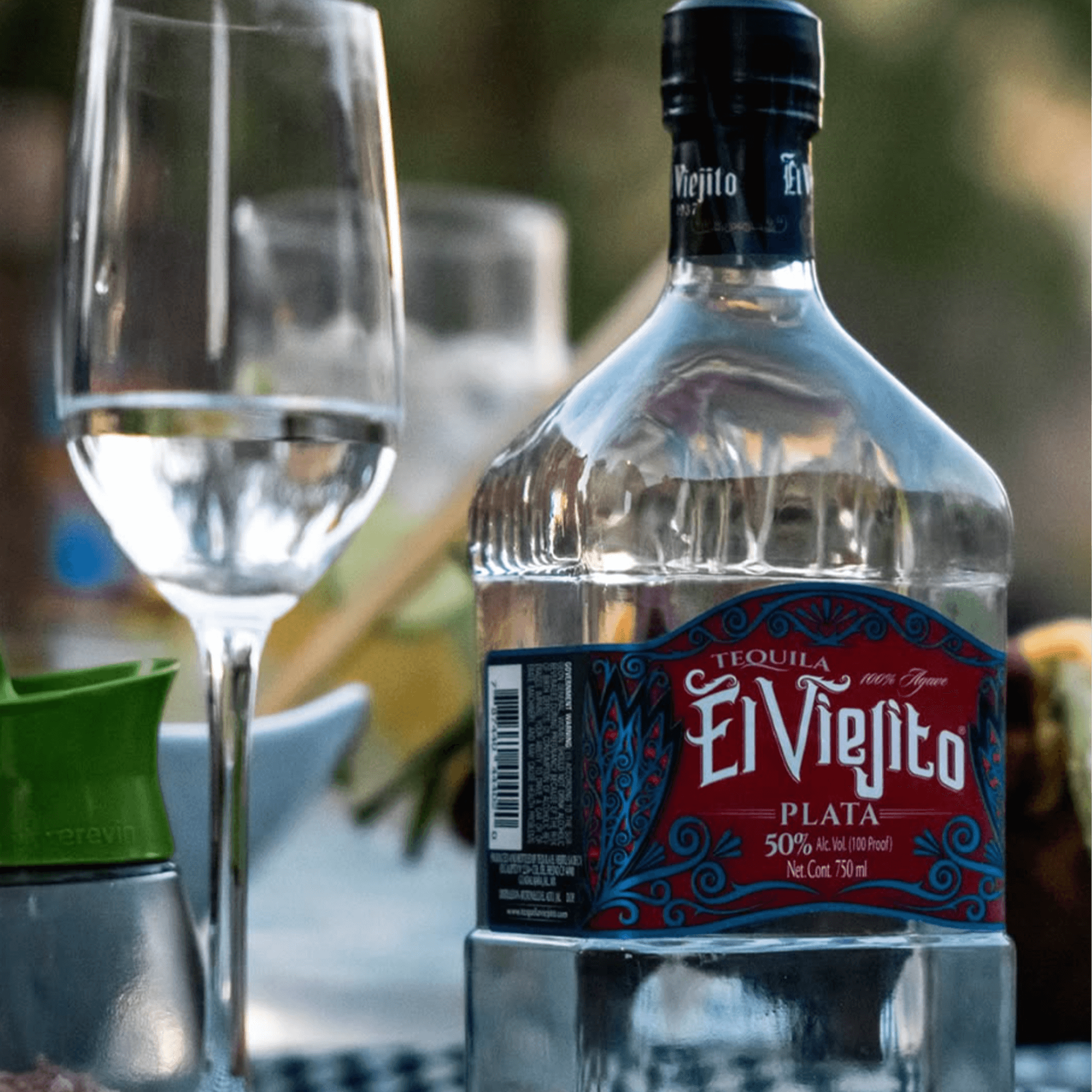 El Viejito Plata 50% tequila bottle beside a glass, showcasing its bold craftsmanship and exceptional quality.