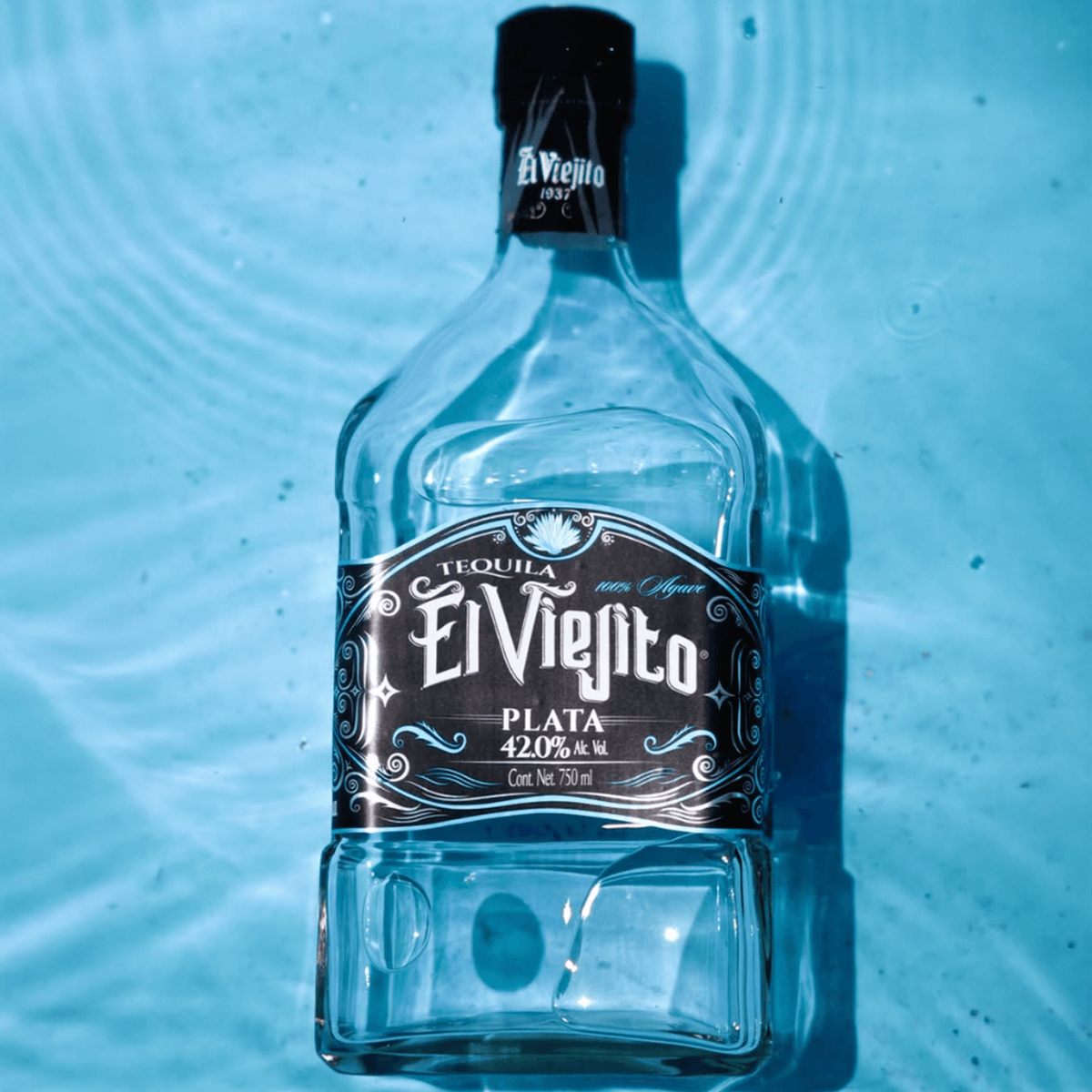 El Viejito Plate Tequila bottle floating in water, showcasing its premium design and 42% alcohol content.