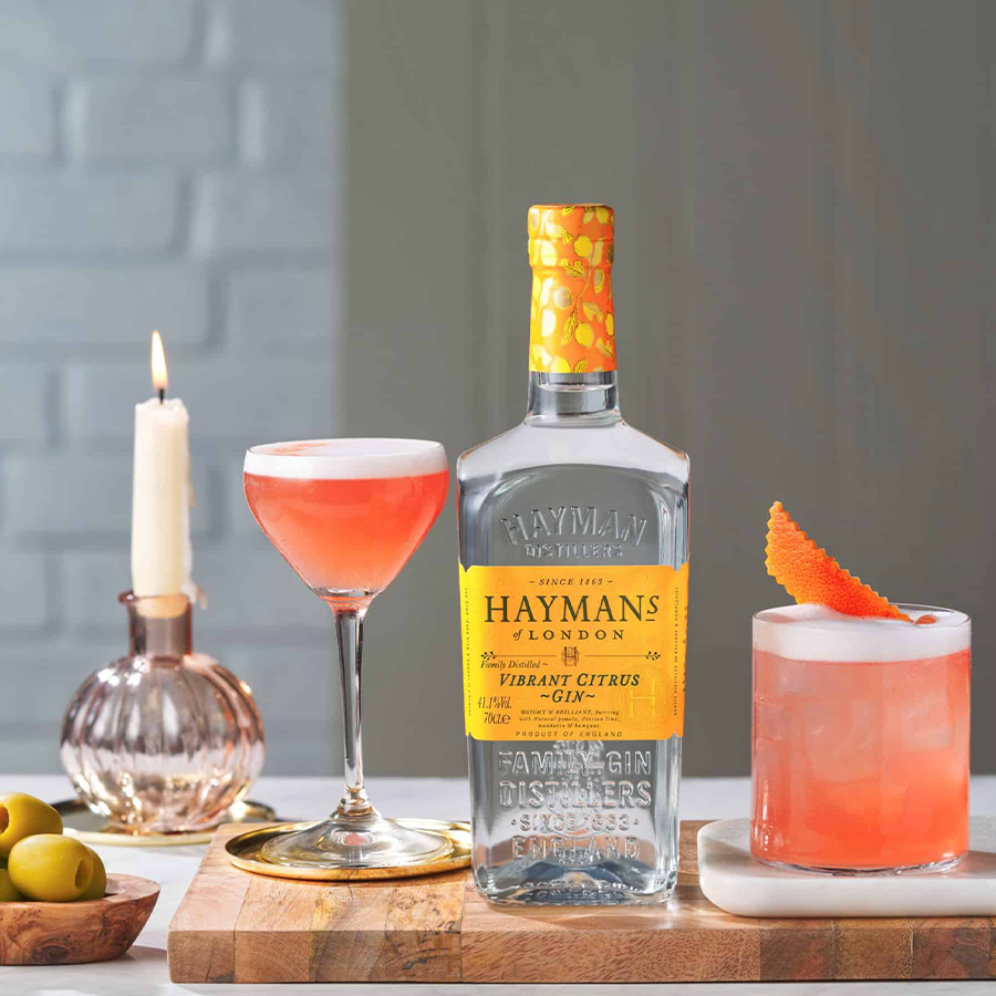 Hayman's Vibrant Citrus Gin bottle with cocktails, highlighting Citrus Gin's vibrant flavors and refreshing finish.