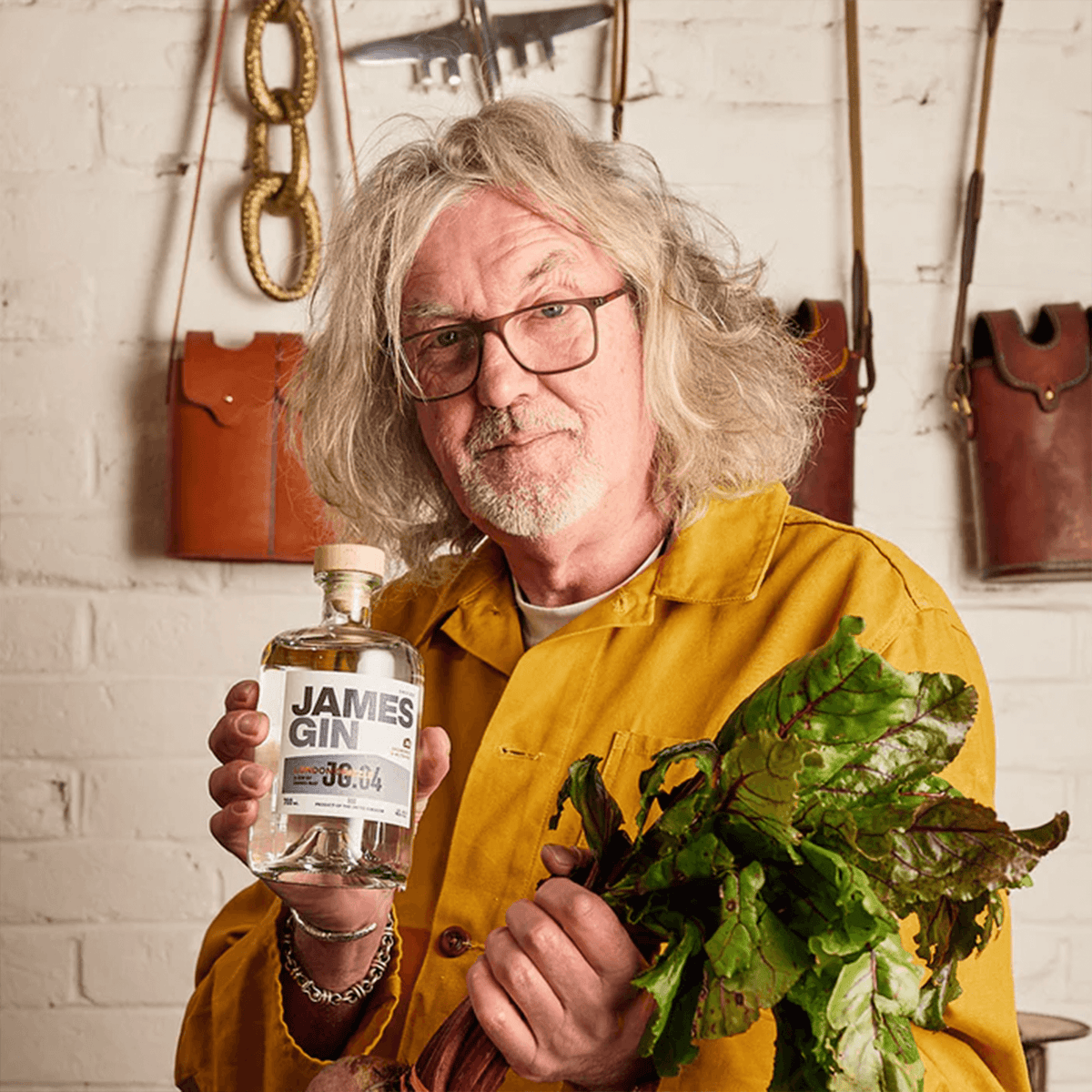 James Gin London Drizzle 700ml held by a man in yellow shirt, showcasing its unique blend and artisan quality.