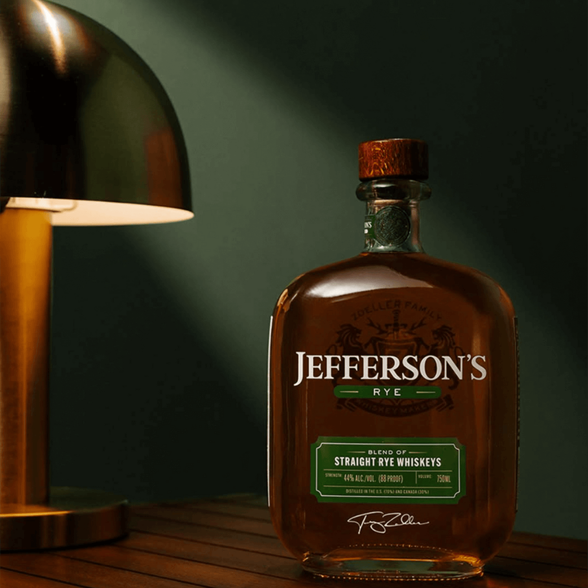 Bottle of Jefferson's Rye Whiskey on a wooden table beside a stylish lamp, showcasing its unique blend and rich color.