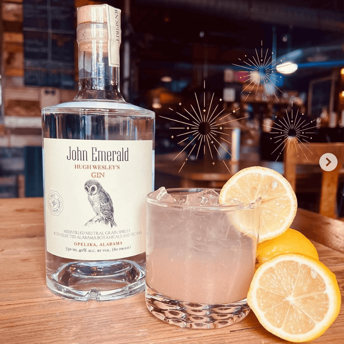 Bottle of John Emerald Hugh Wesley's Gin with a refreshing cocktail and fresh lemons, celebrating Southern craftsmanship.