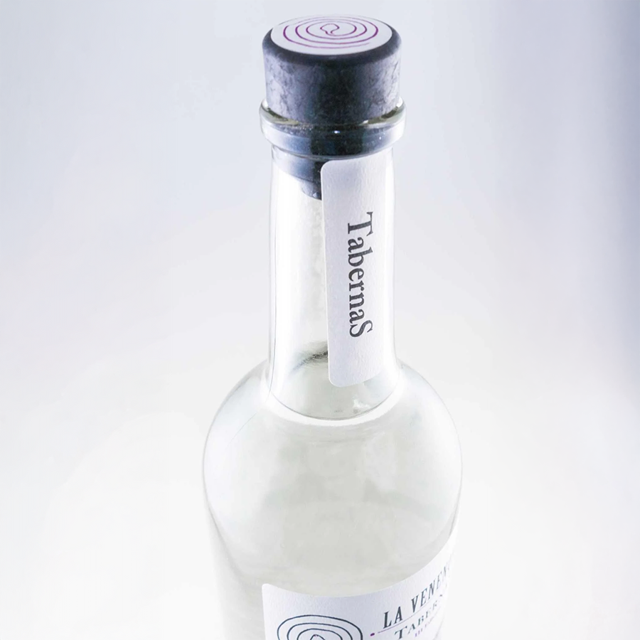 La Venenosa Tabernas Raicilla bottle with modern label design and cork top.