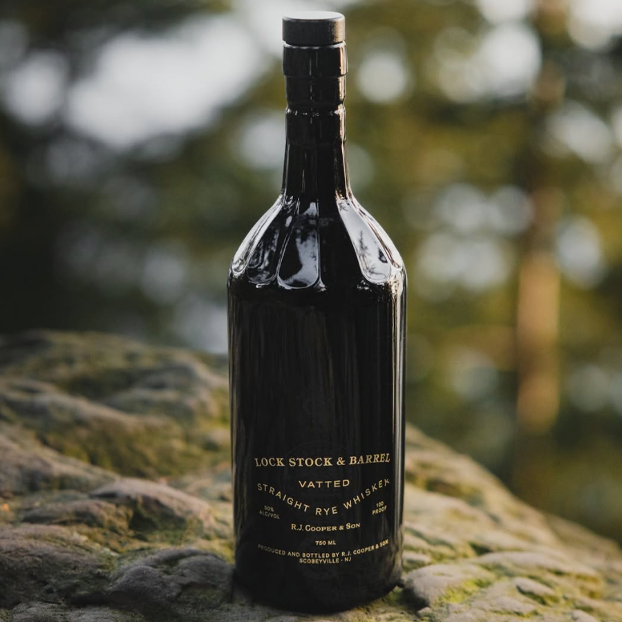 Lock Stock & Barrel Vatted Straight Rye Whiskey bottle on a rock background, showcasing its distinctive design.