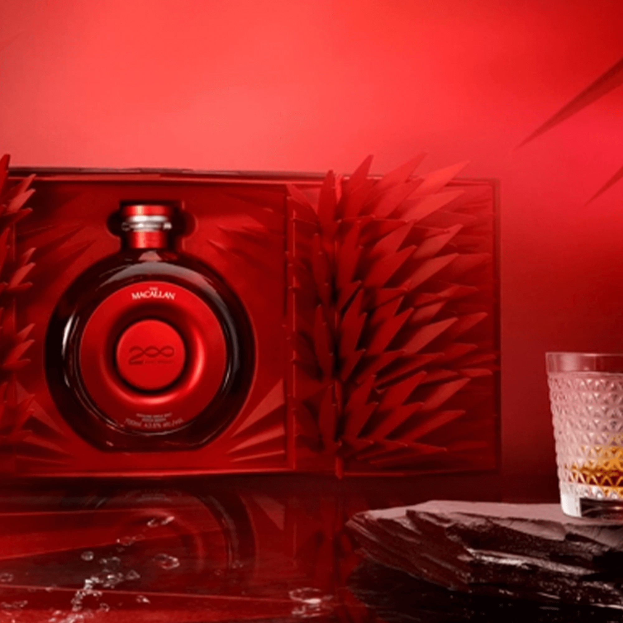 Macallan Time Space Mastery Single Malt Scotch Whisky 700ml in a striking red presentation box with a glass.