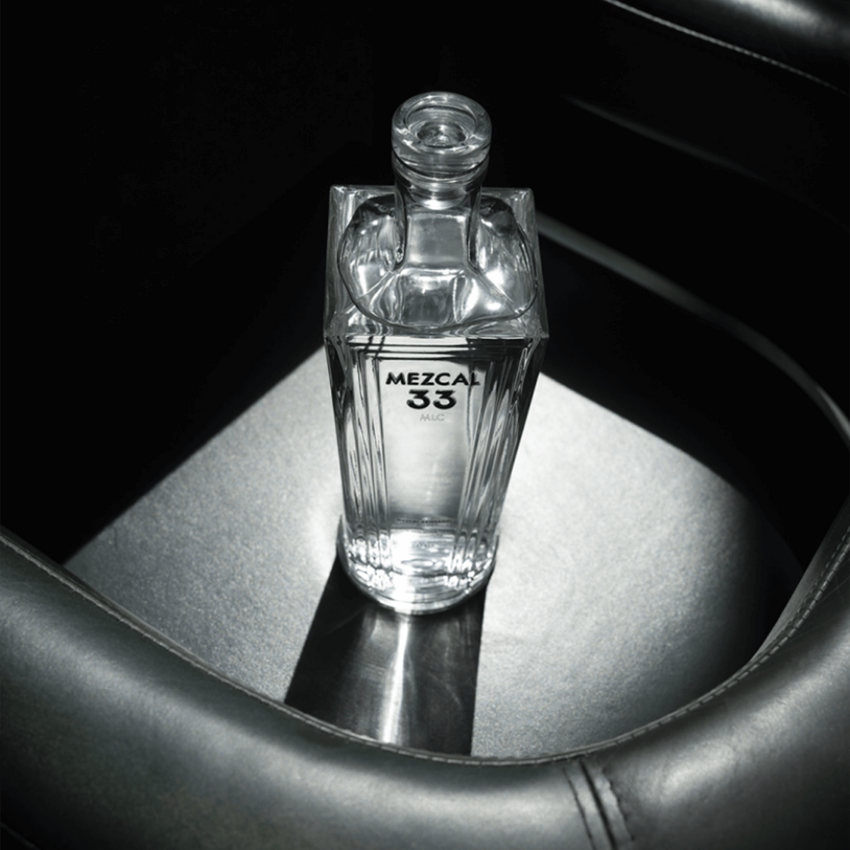 Mezcal 33 Joven Espadin bottle showcasing premium quality and craftsmanship with vibrant clarity.