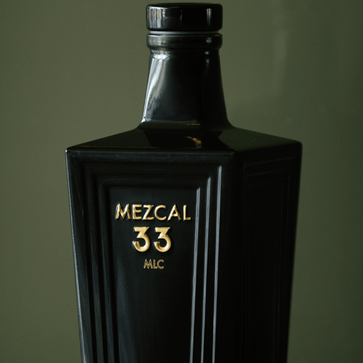 Mezcal 33 Reposado Espadin bottle with elegant design, showcasing premium mezcal aged in oak barrels.