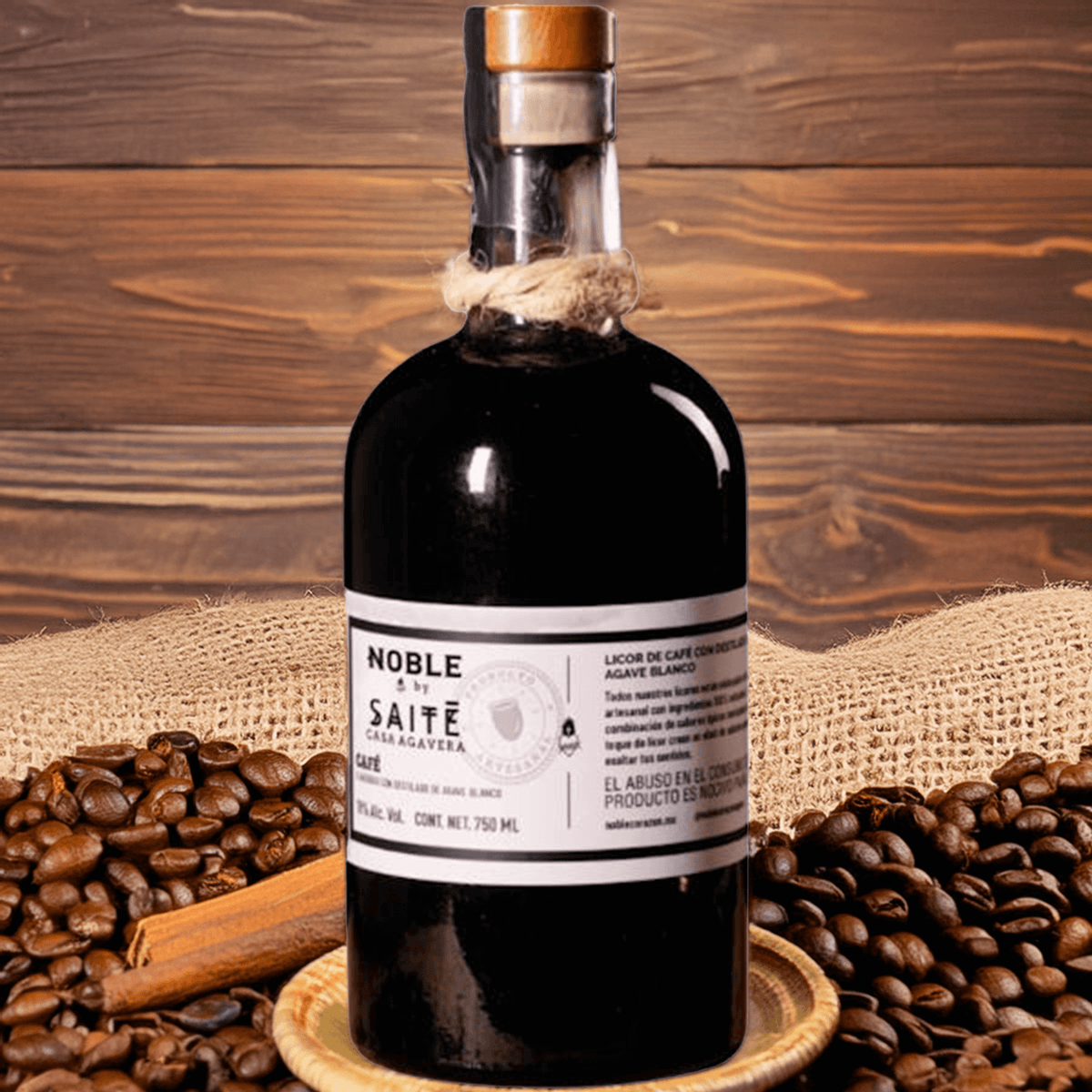 Noble by Saite Coffee Liqueur bottle on a rustic backdrop with coffee beans and cinnamon stick.