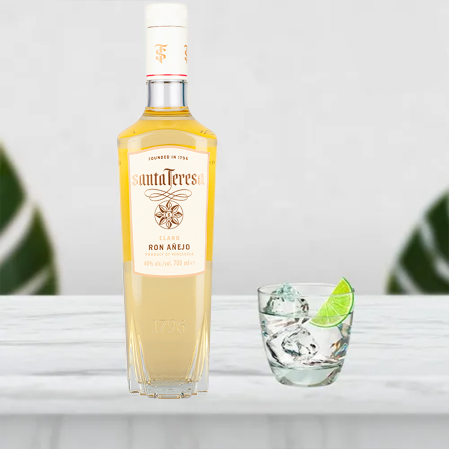 Santa Teresa Claro Ron Añejo bottle with glass and ice, showcasing fine Venezuelan light rum.
